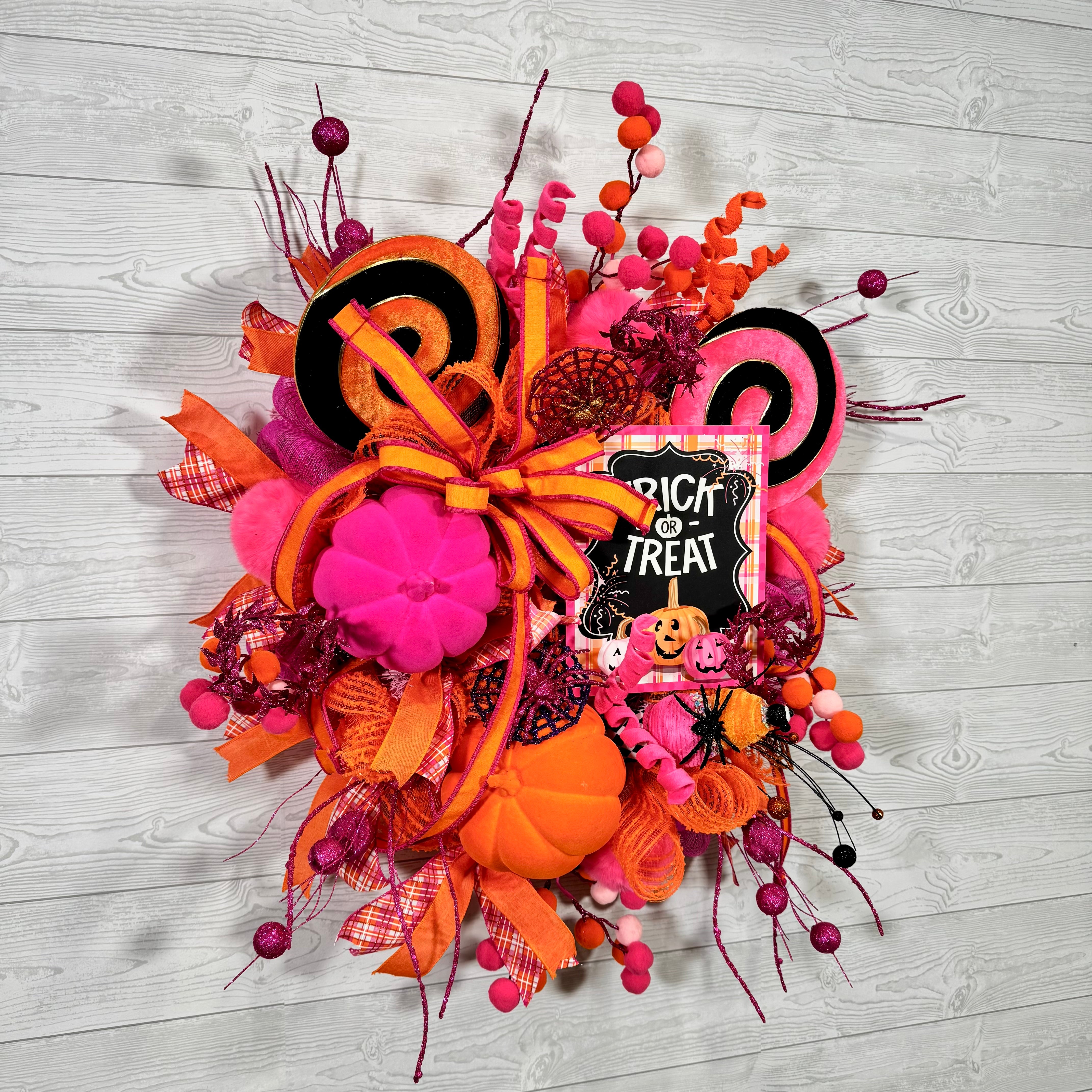 Bright Pink and Orange Halloween Wreath with Trick or Treat Sign, Pumpkins, Candy Swirls, and Whimsical Spooky Accents