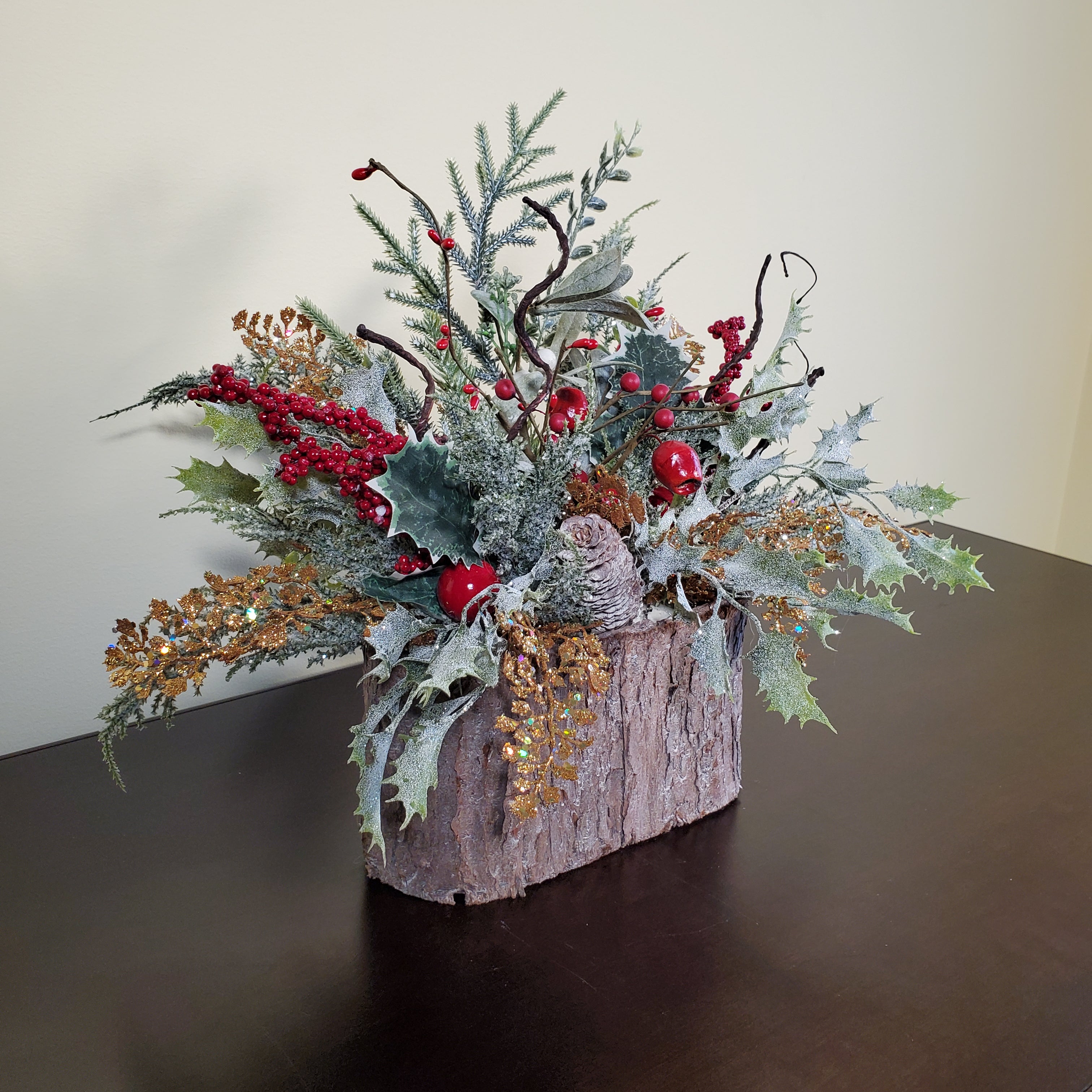 Frosted Christmas Arrangement with Red Berries, Pinecones, and Winter Greens in Bark-Style Container