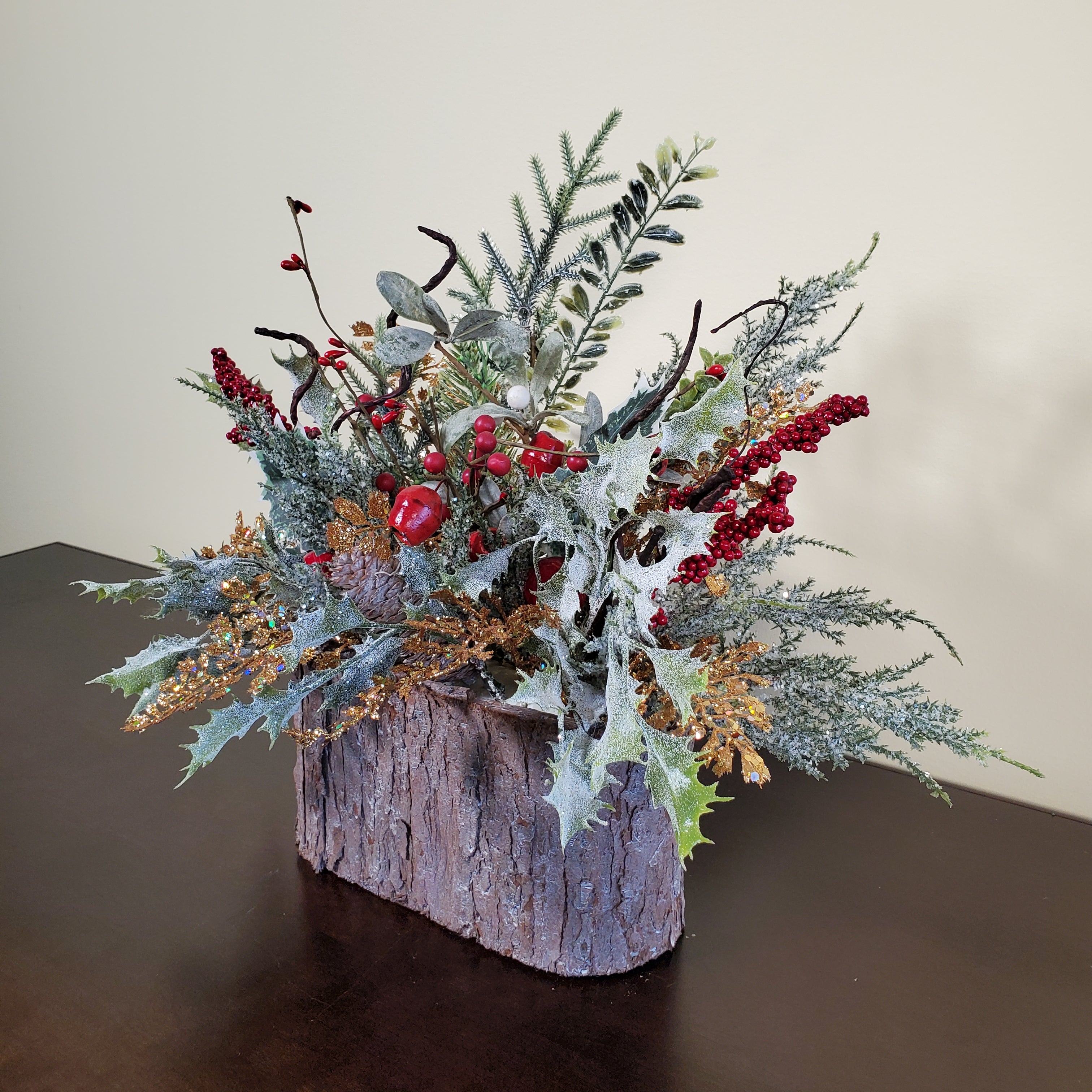 Frosted Christmas Arrangement with Red Berries, Pinecones, and Winter Greens in Bark-Style Container