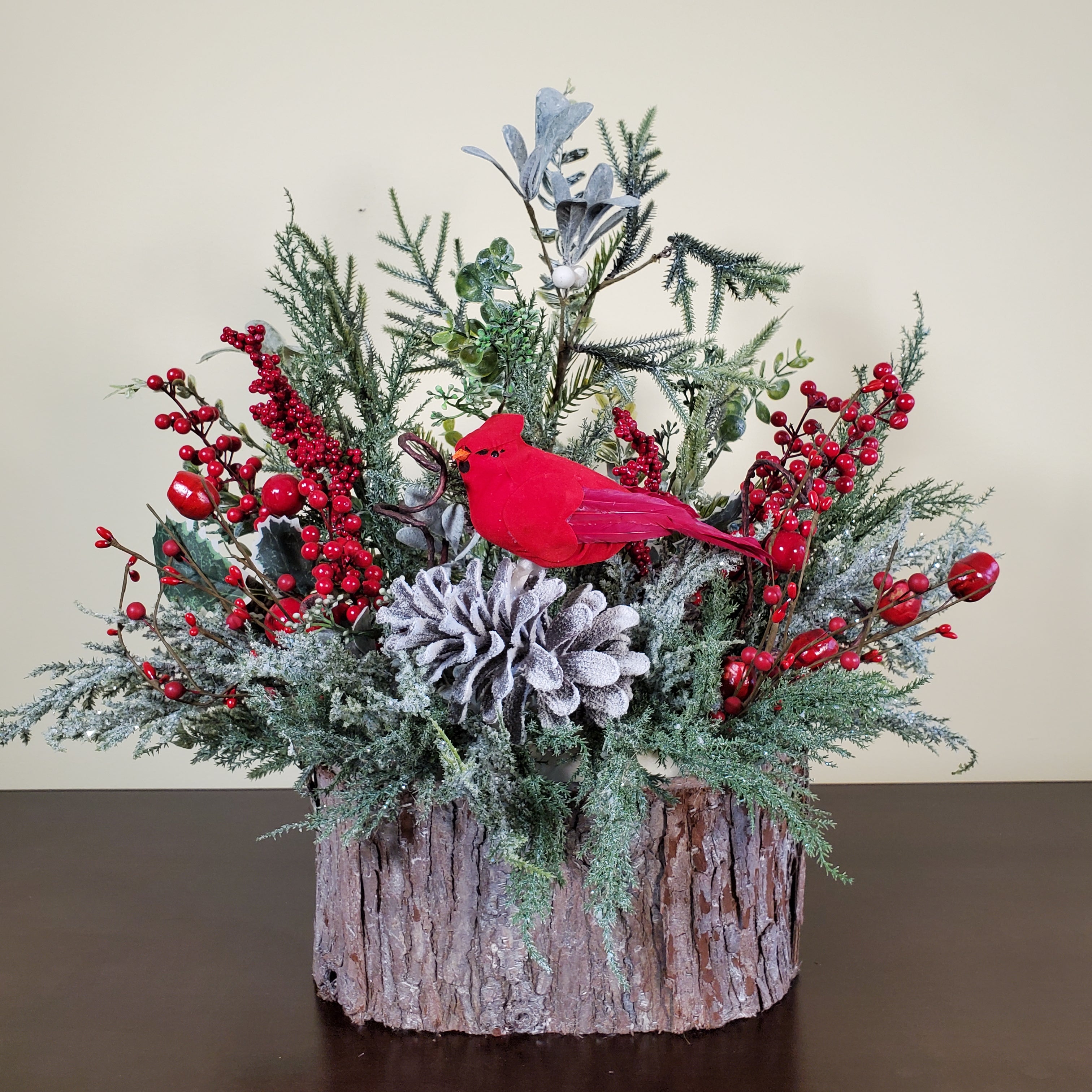 Cardinal Christmas Arrangement with Frosted Pine, Red Berries, and Winter Greens in Bark-Style Container