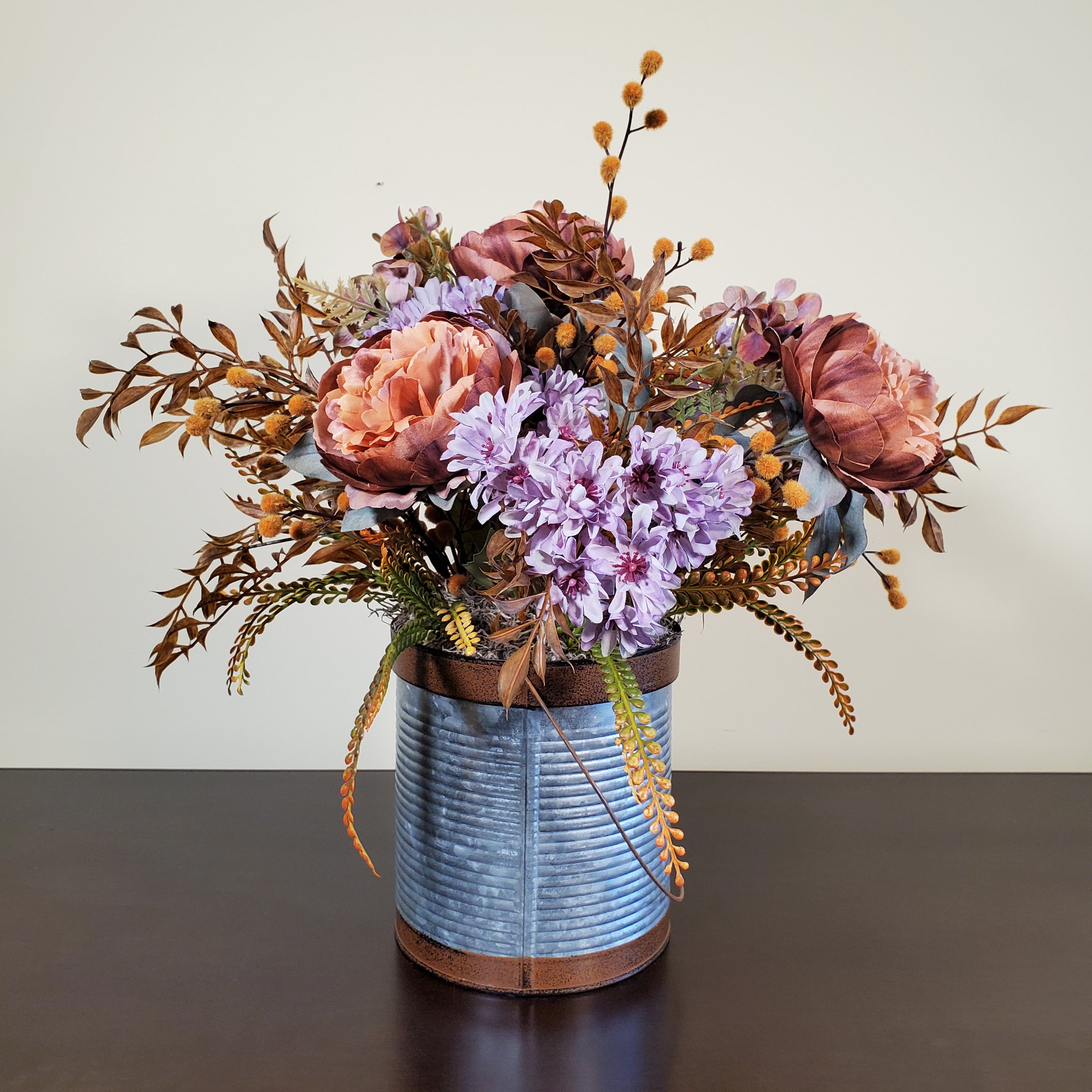 Fall Floral Arrangement with Peach Peonies, Lavender Mums, and Autumn Foliage in Textured Metal Container