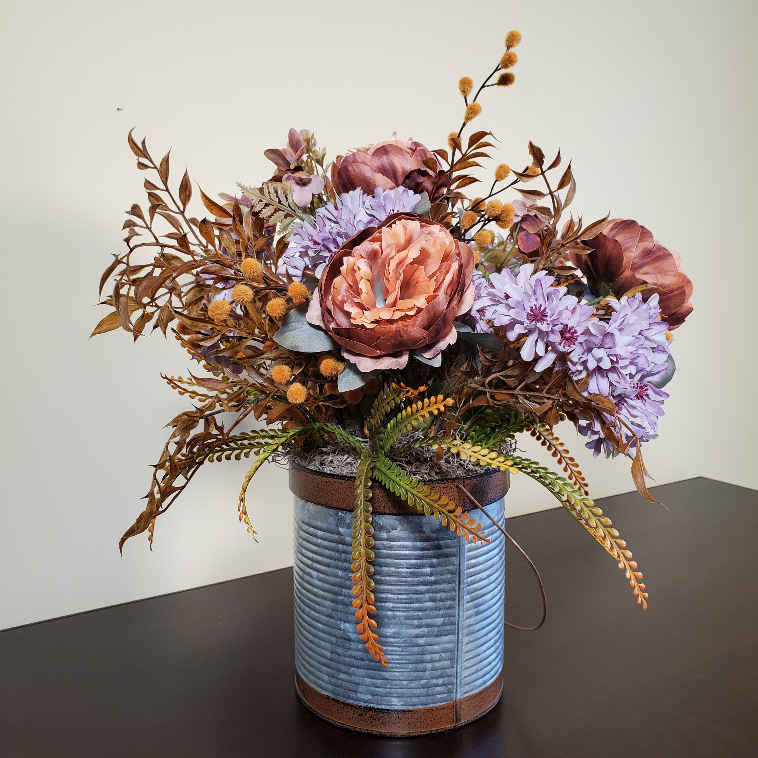 Fall Floral Arrangement with Peach Peonies, Lavender Mums, and Autumn Foliage in Textured Metal Container