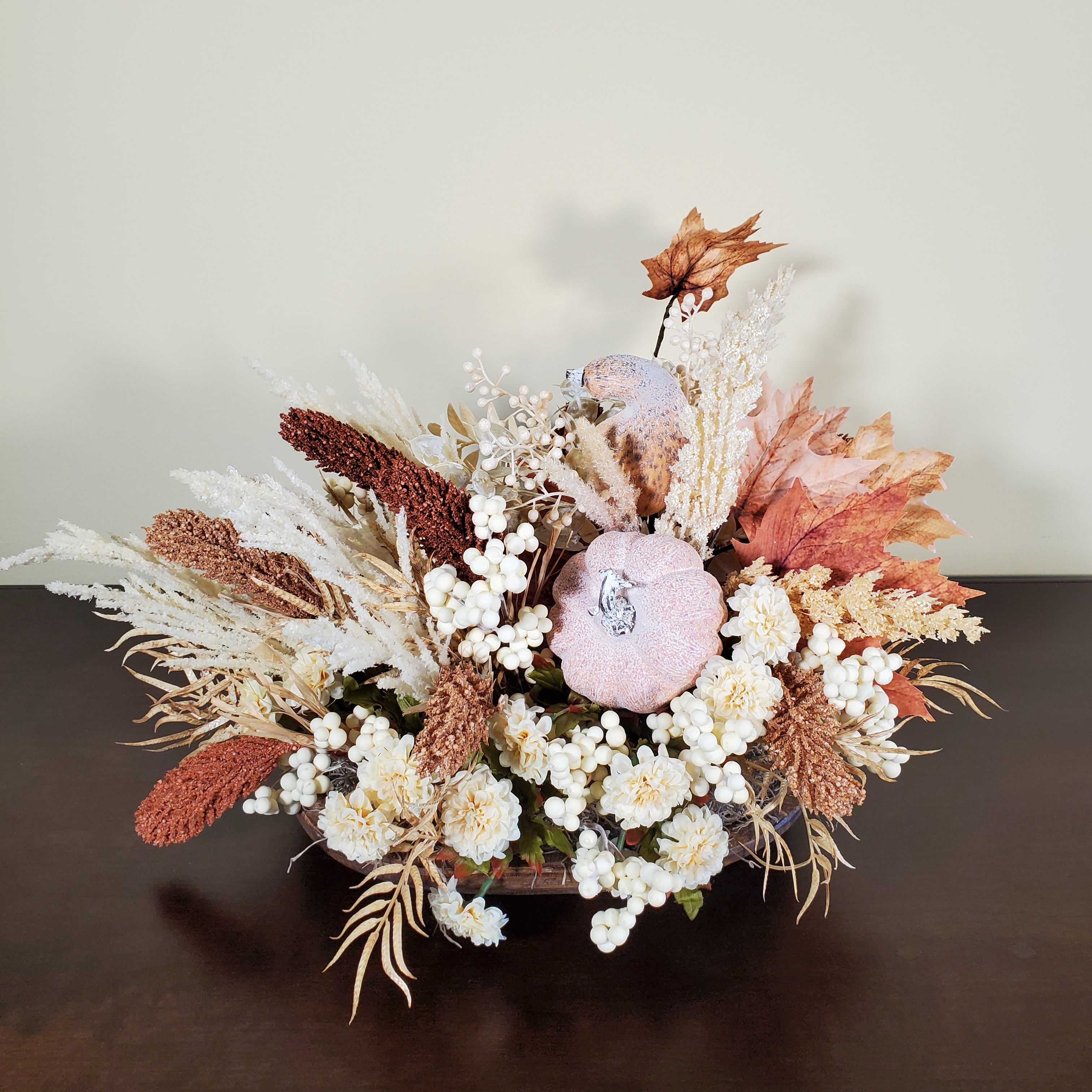 Neutral Fall Pumpkin Centerpiece with Cream Florals, White Berries, and Autumn Grasses in Rustic Oval Base