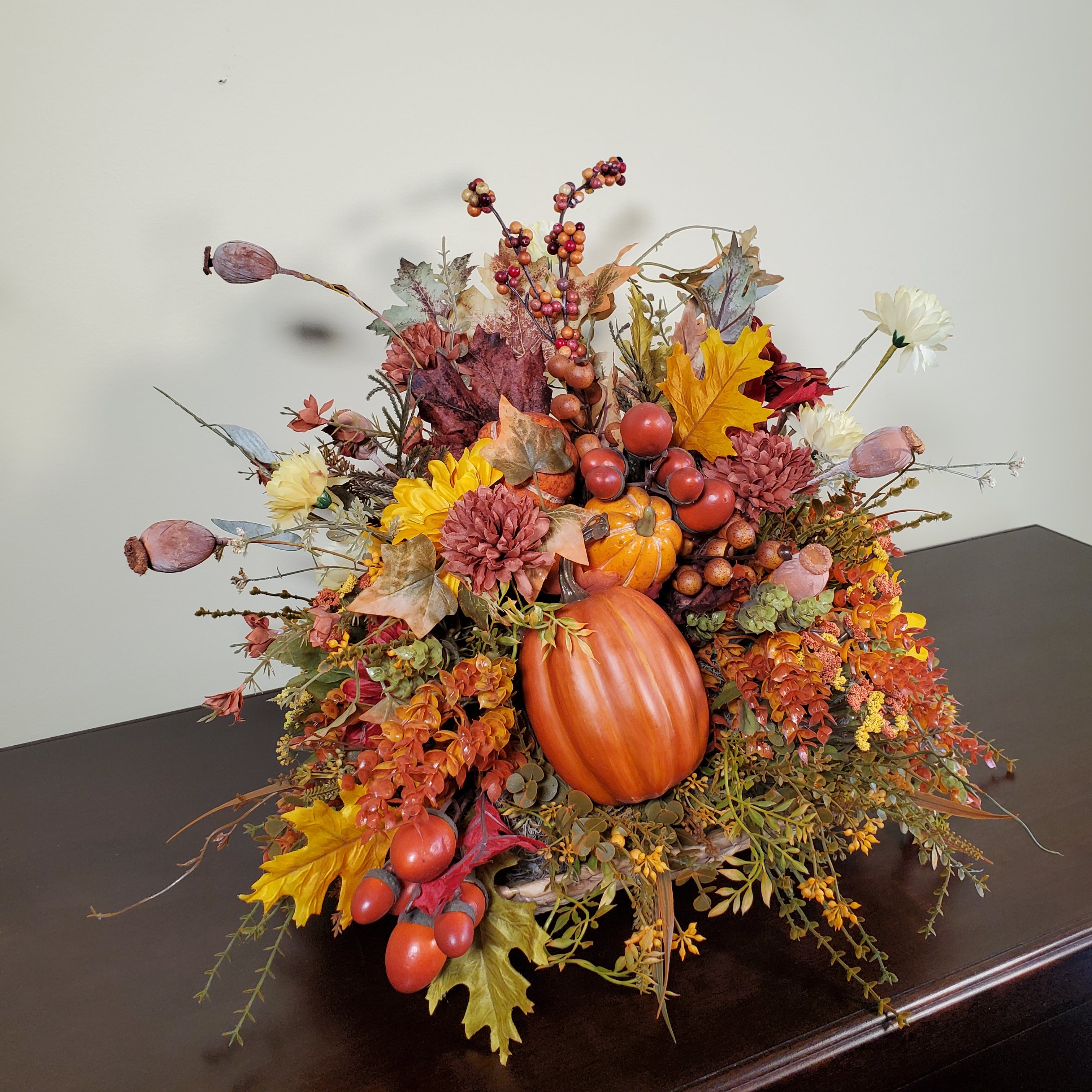 Fall Pumpkin Centerpiece with Autumn Leaves, Berries, and Seasonal Florals in Warm Harvest Colors
