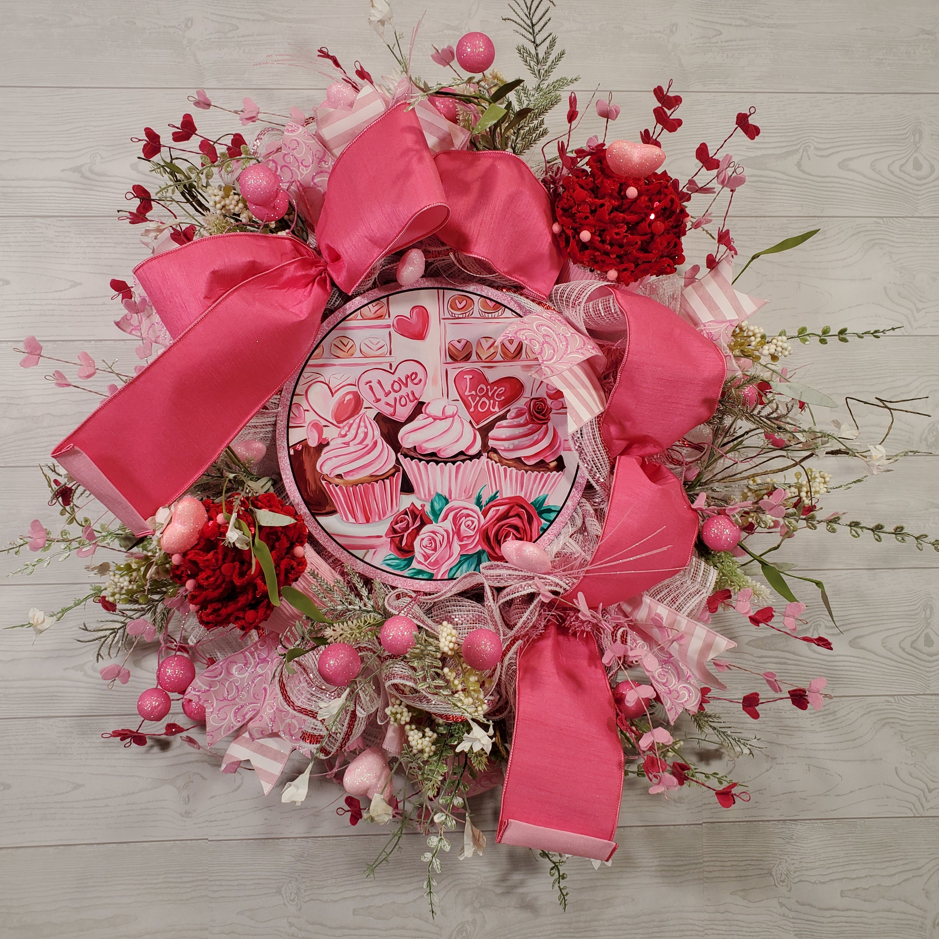 Valentine Cupcake Wreath with Pink Bow, Heart Accents, Sweet Treat Artwork, and Romantic Pink Floral Design