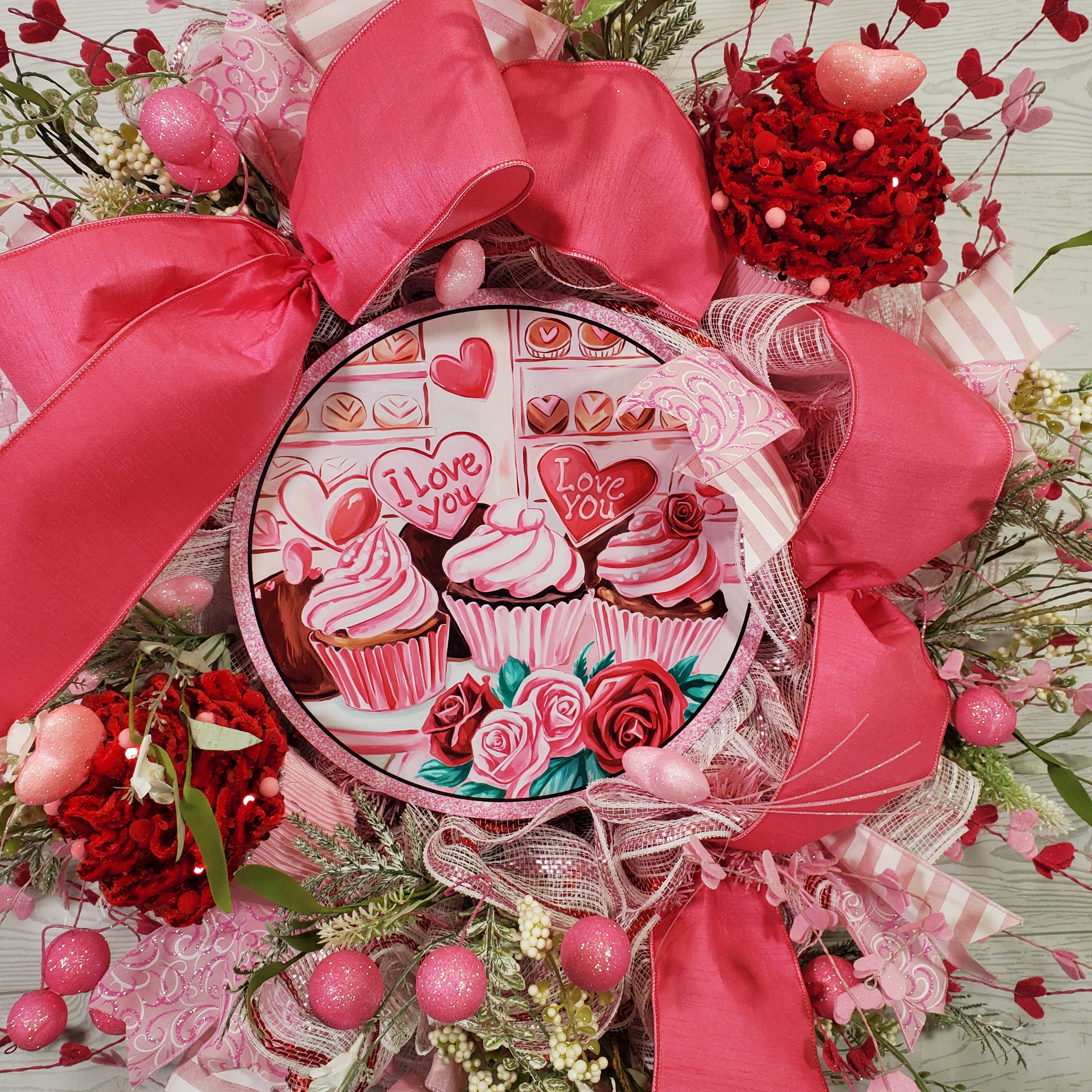 Valentine Cupcake Wreath with Pink Bow, Heart Accents, Sweet Treat Artwork, and Romantic Pink Floral Design