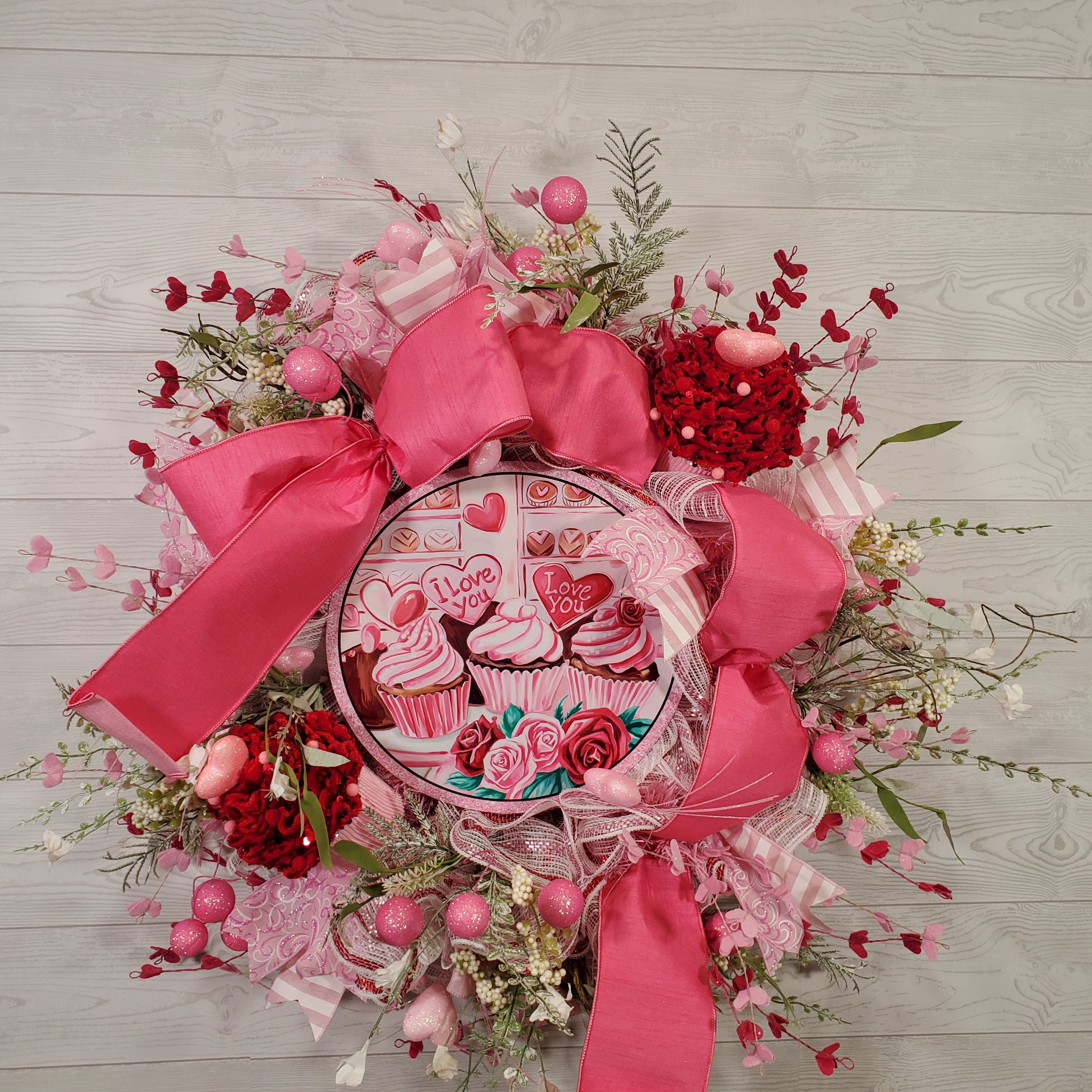 Valentine Cupcake Wreath with Pink Bow, Heart Accents, Sweet Treat Artwork, and Romantic Pink Floral Design