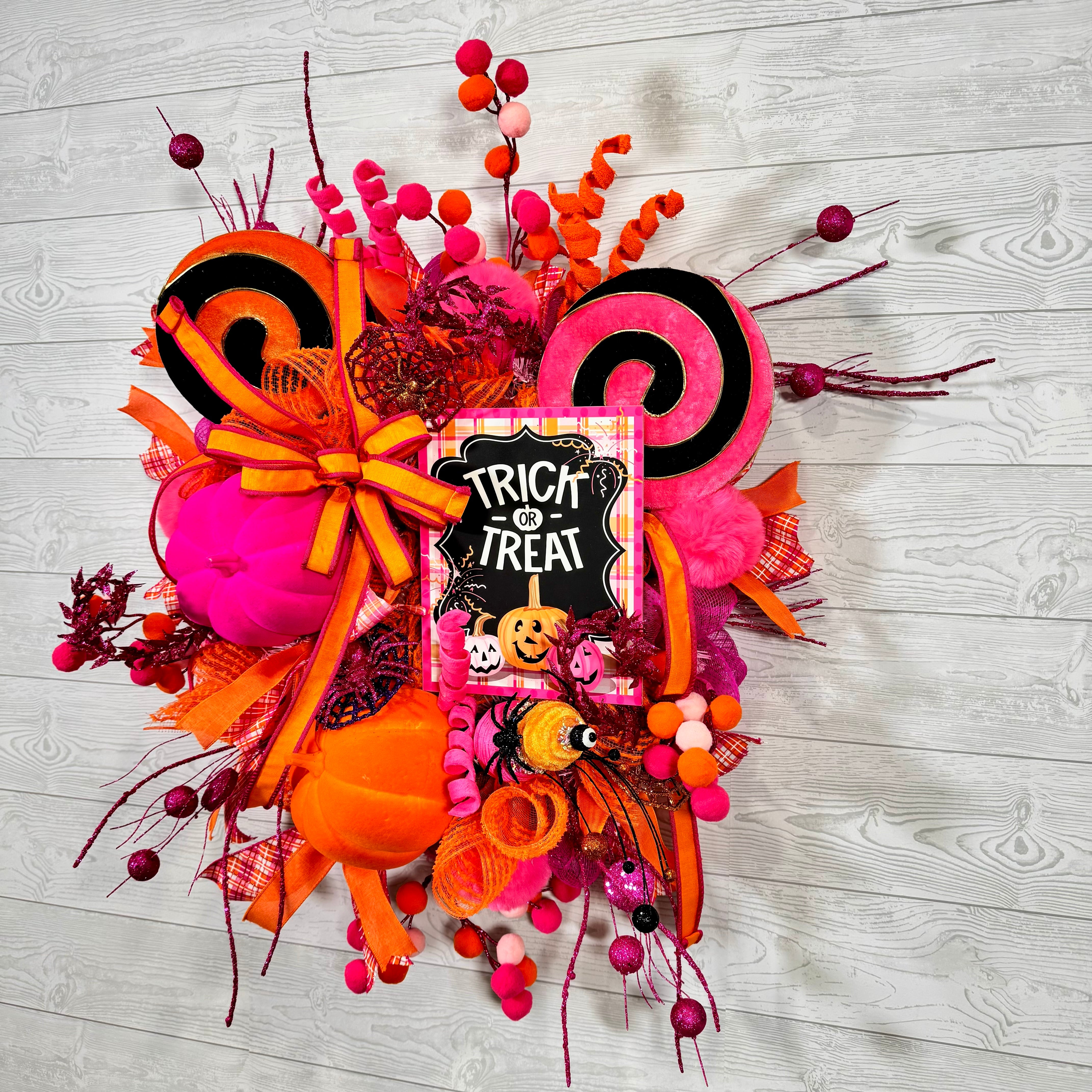 Bright Pink and Orange Halloween Wreath with Trick or Treat Sign, Pumpkins, Candy Swirls, and Whimsical Spooky Accents