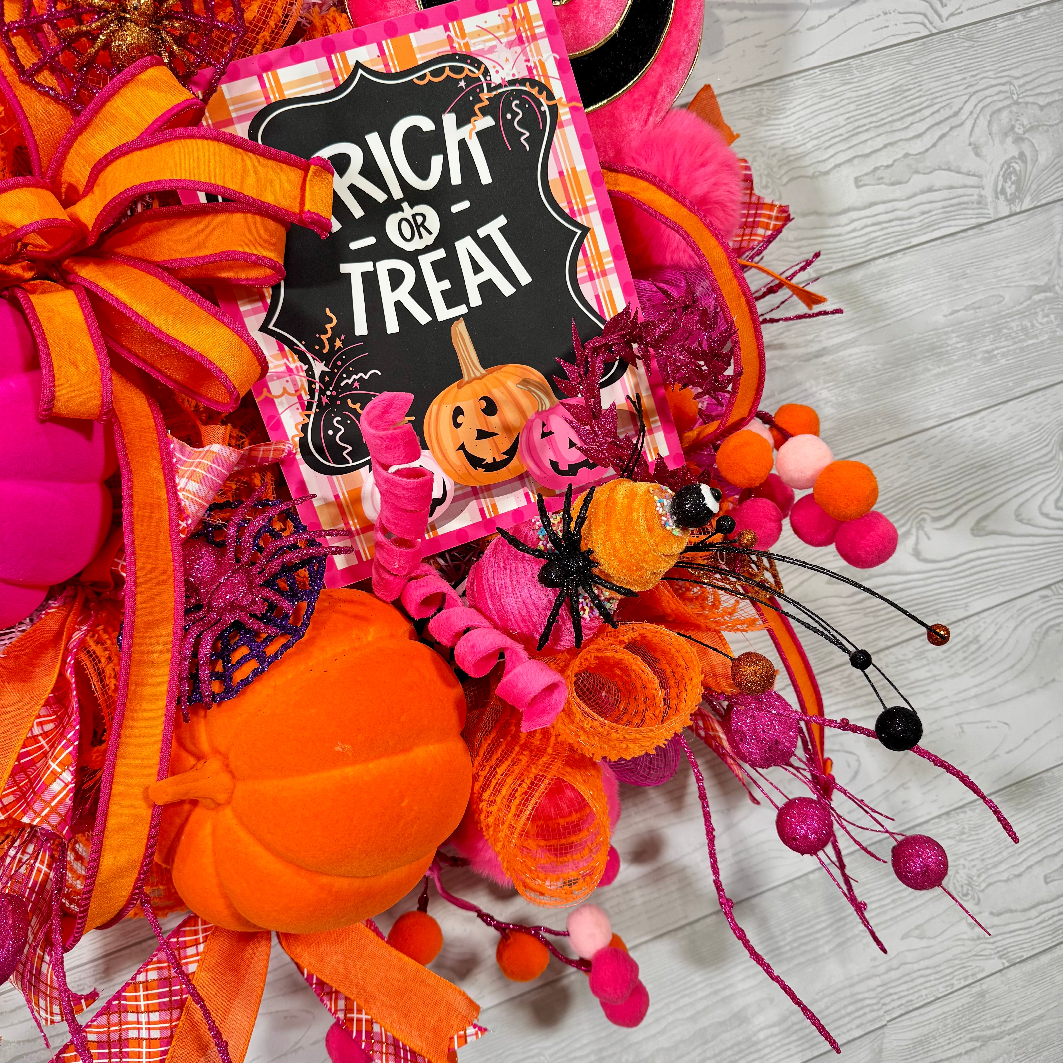 Bright Pink and Orange Halloween Wreath with Trick or Treat Sign, Pumpkins, Candy Swirls, and Whimsical Spooky Accents