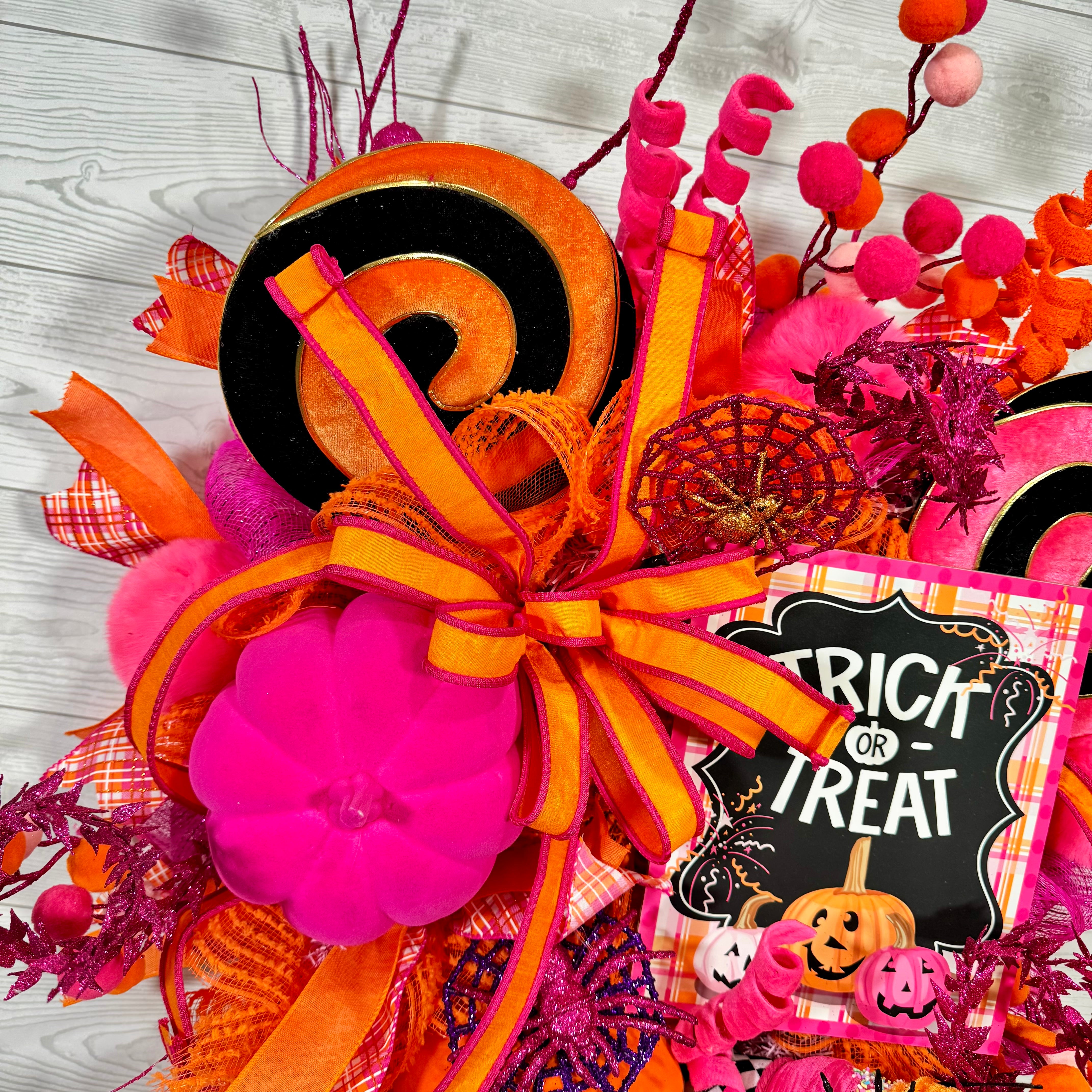 Bright Pink and Orange Halloween Wreath with Trick or Treat Sign, Pumpkins, Candy Swirls, and Whimsical Spooky Accents