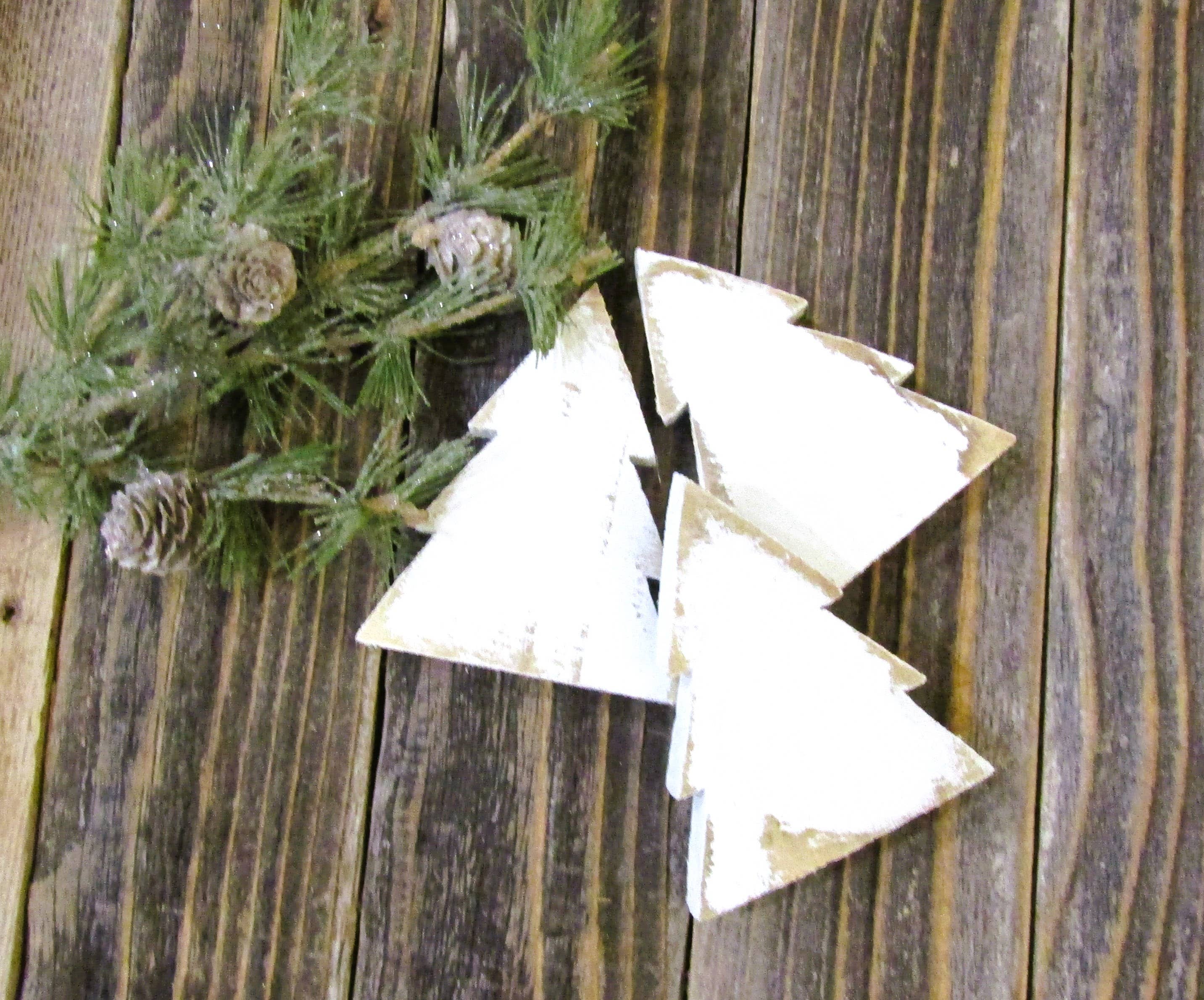 White distressed wood Christmas tree bowl fillers on barn wood with pine and pinecones