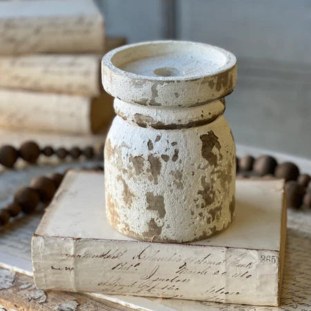 Decorative wood candle holder on an old book with a blurred background