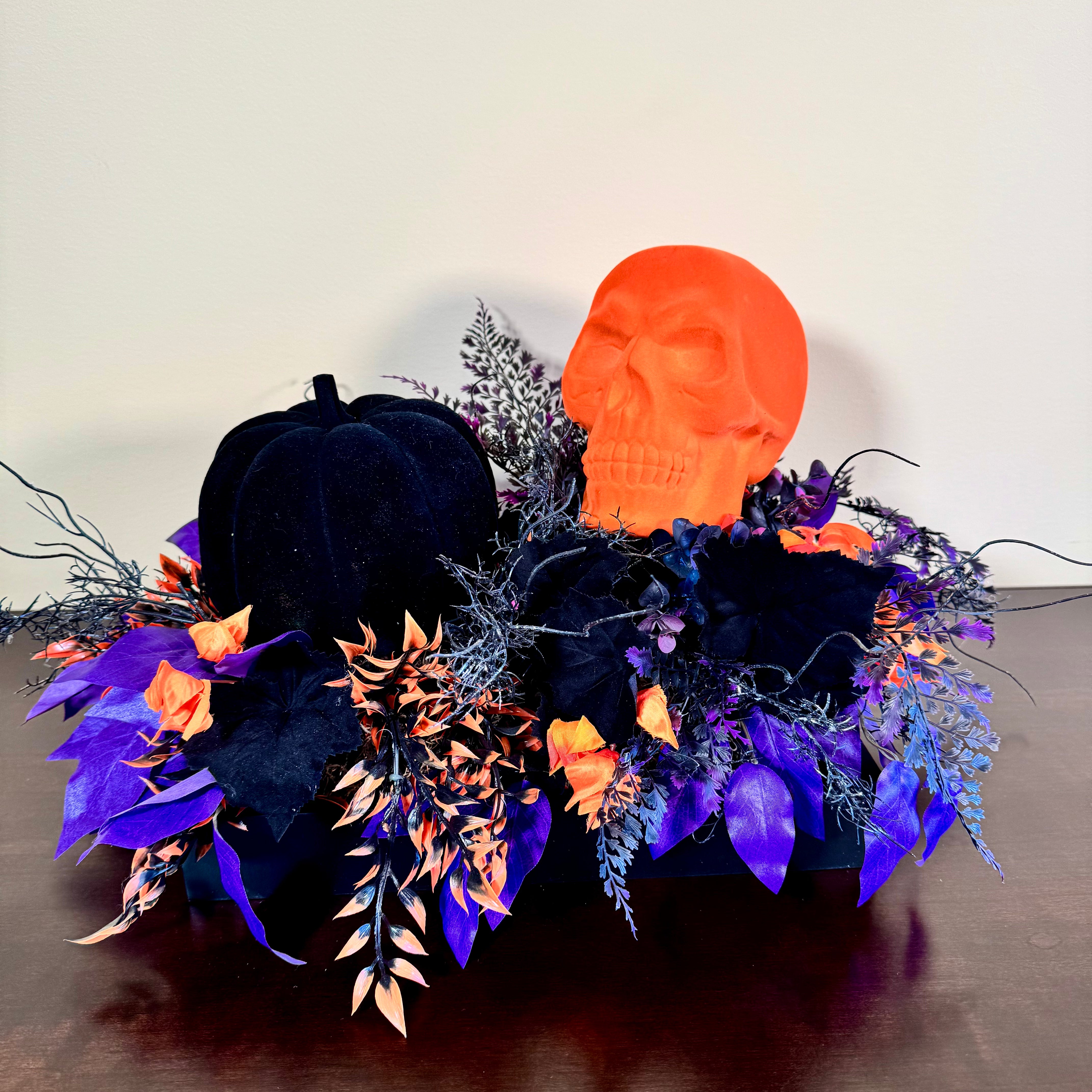 Halloween Arrangement with Neon Skull, Velvet Pumpkin & Bold Foliage in Black Wooden Tray