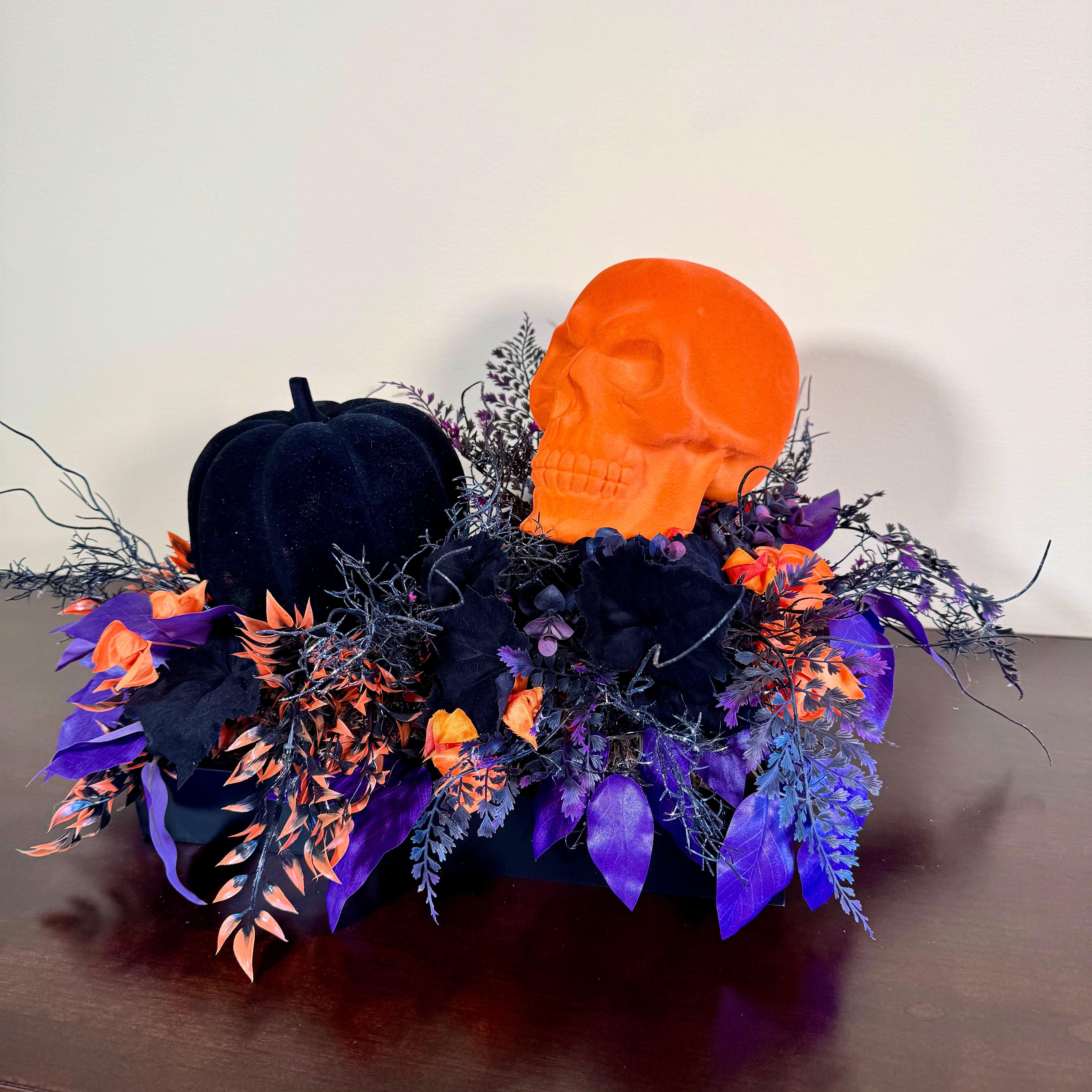 Halloween Arrangement with Neon Skull, Velvet Pumpkin & Bold Foliage in Black Wooden Tray