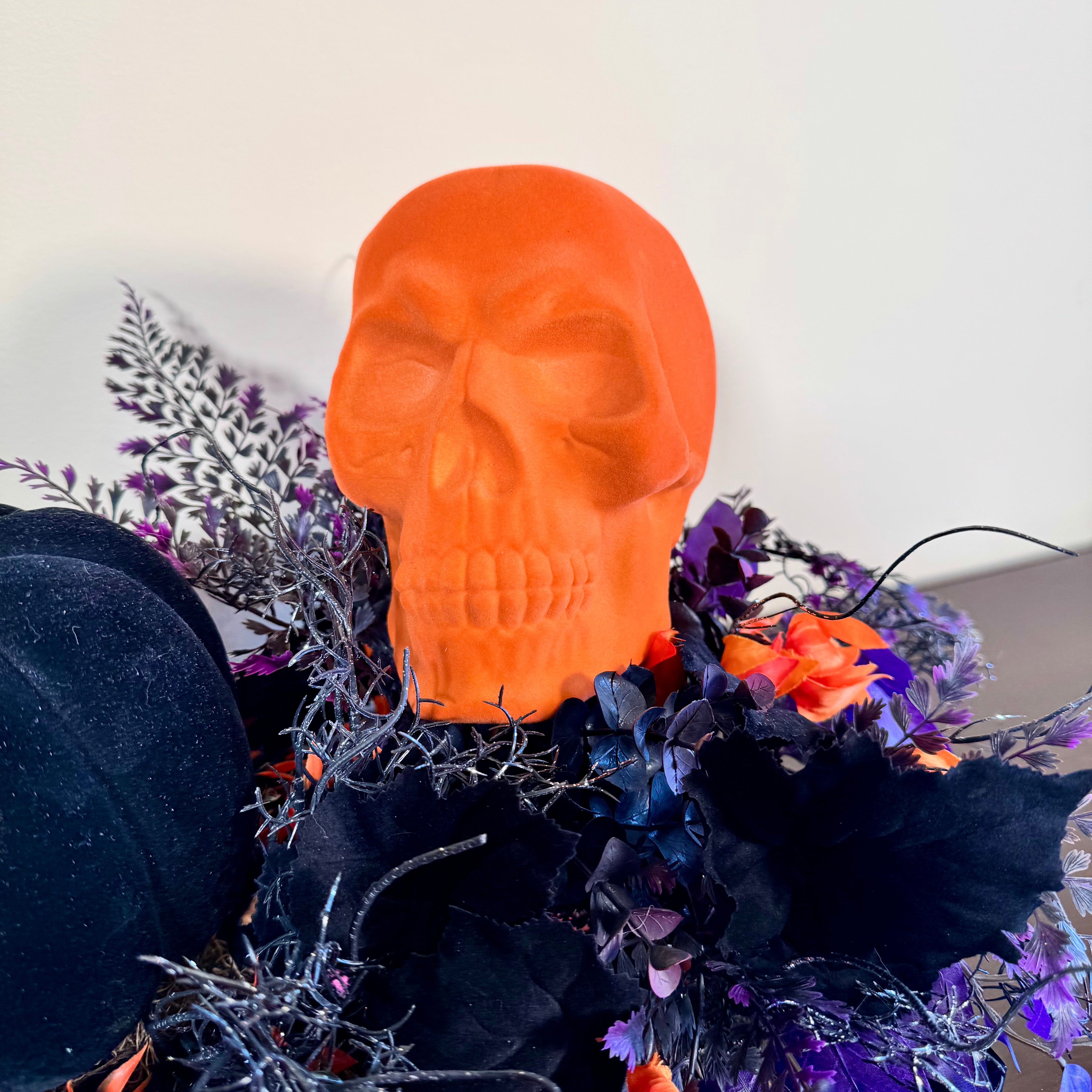 Halloween Arrangement with Neon Skull, Velvet Pumpkin & Bold Foliage in Black Wooden Tray