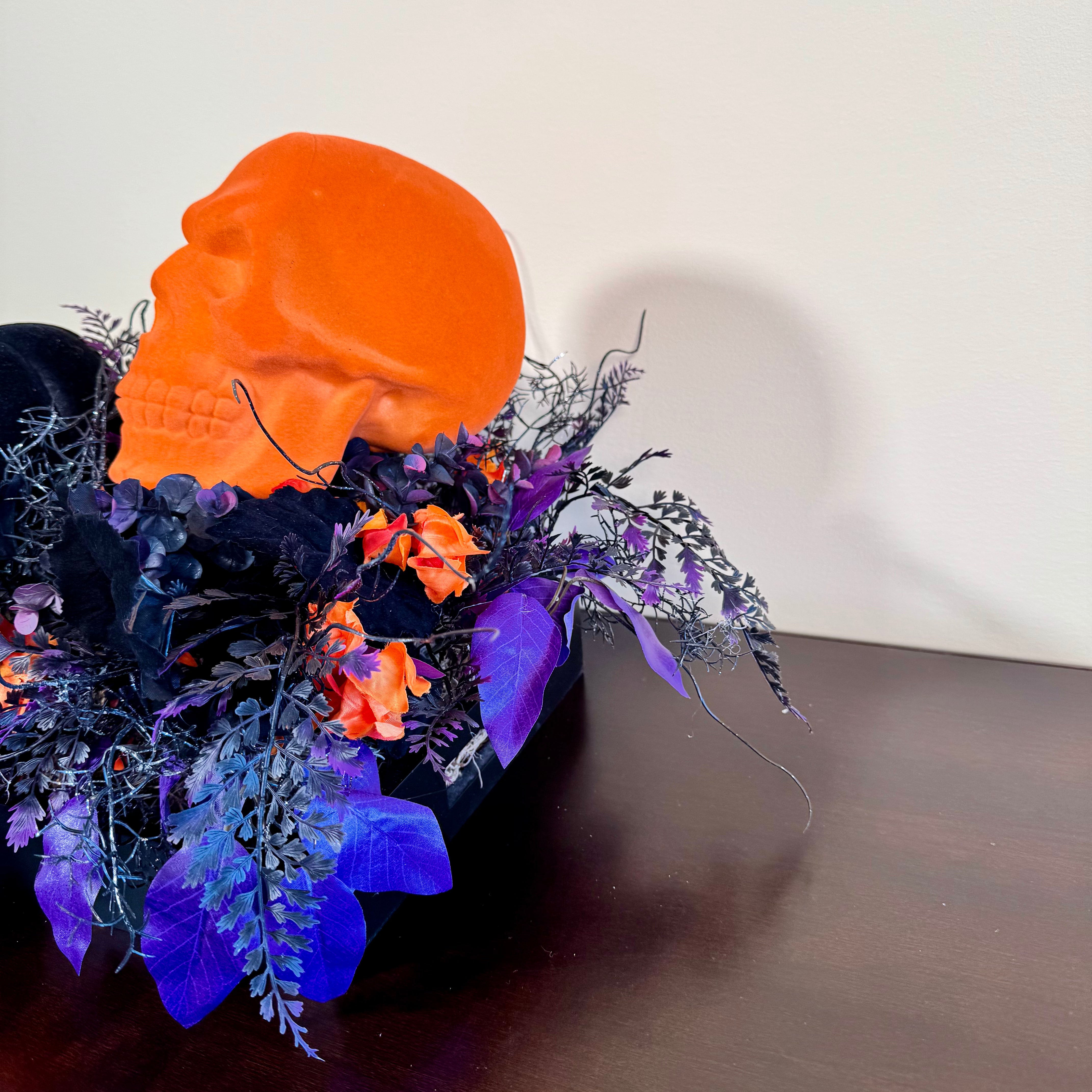 Halloween Arrangement with Neon Skull, Velvet Pumpkin & Bold Foliage in Black Wooden Tray