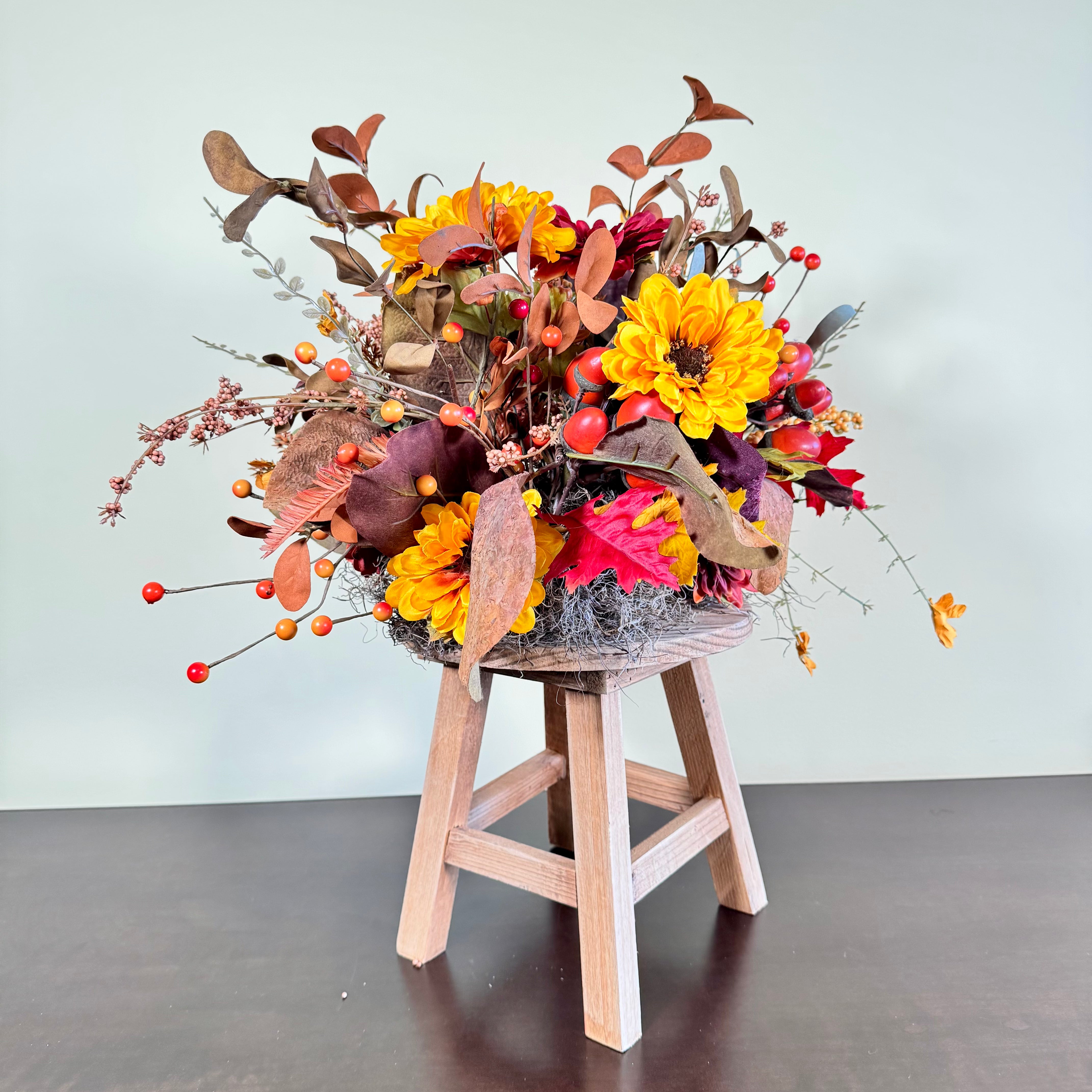 Fall Floral Arrangement with Sunflowers Berries and Leaves on Rustic Wood Stand