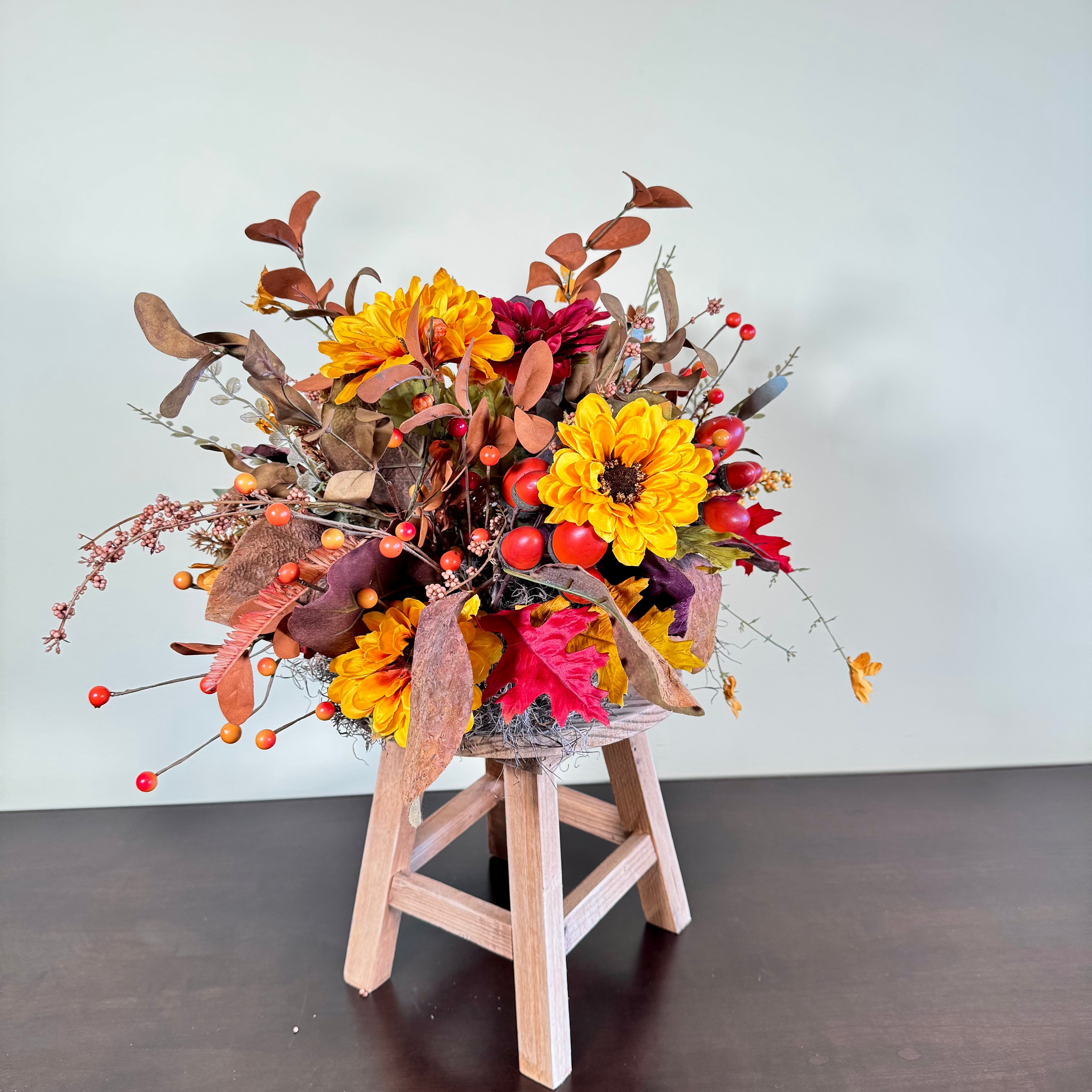 Fall Floral Arrangement with Sunflowers Berries and Leaves on Rustic Wood Stand
