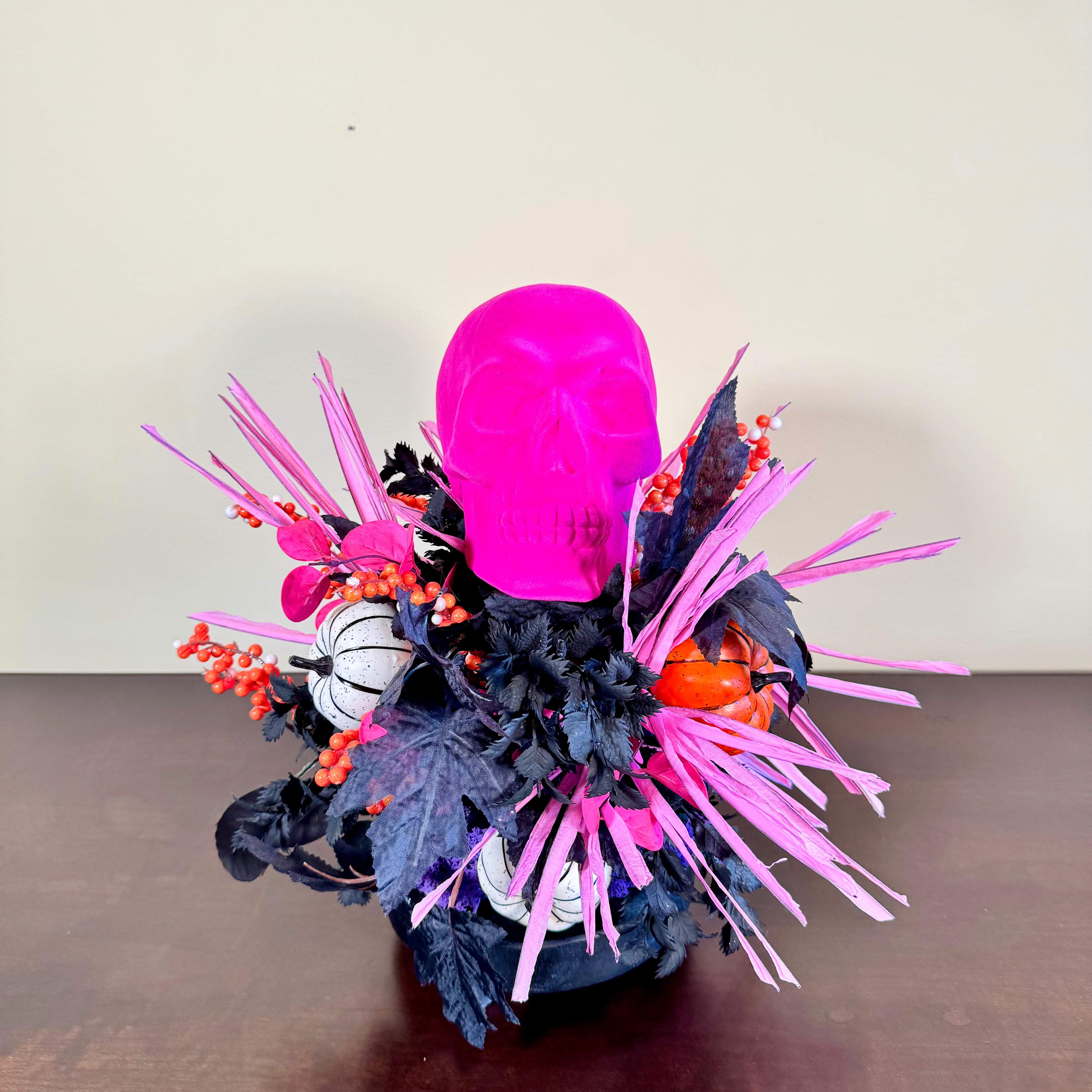 Pink Skull Halloween Arrangement with Black Foliage, Pumpkins and Neon Accents