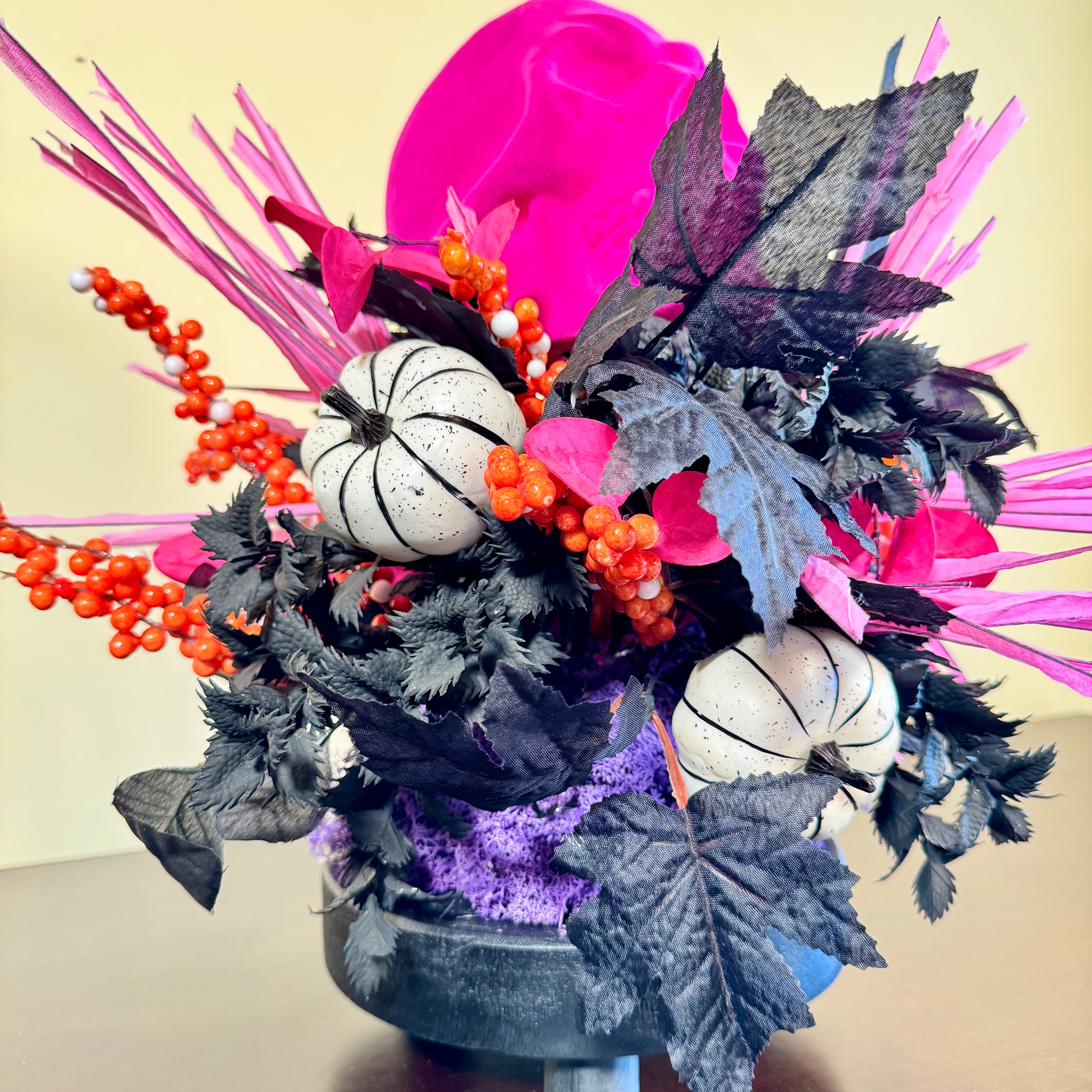 Pink Skull Halloween Arrangement with Black Foliage, Pumpkins and Neon Accents