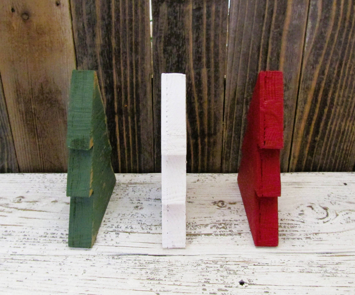 Side view of red, green and white wood Christmas trees showing the 3/4 inch thickness