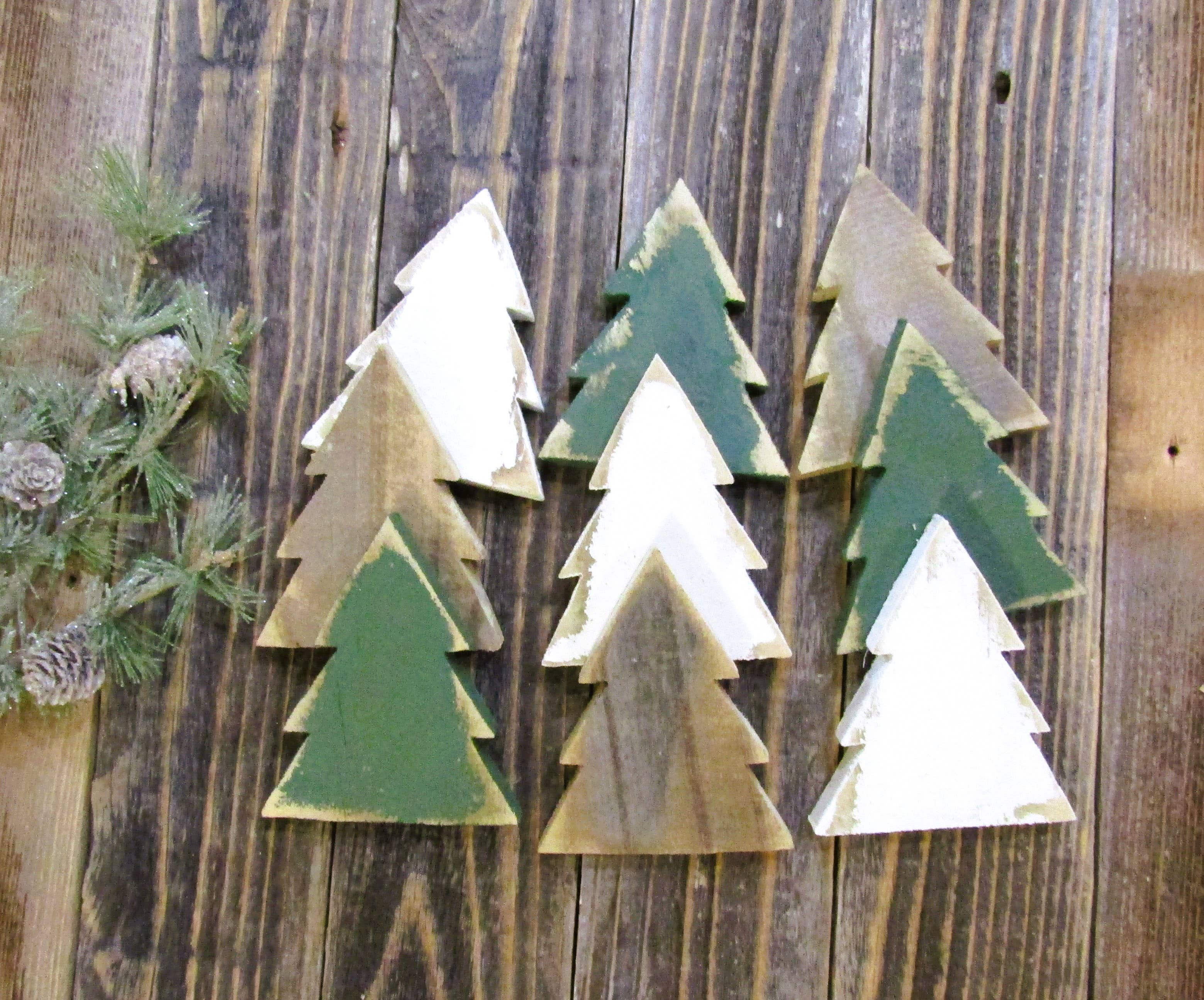 Group of white, green and natural wood Christmas tree bowl fillers with pine greenery