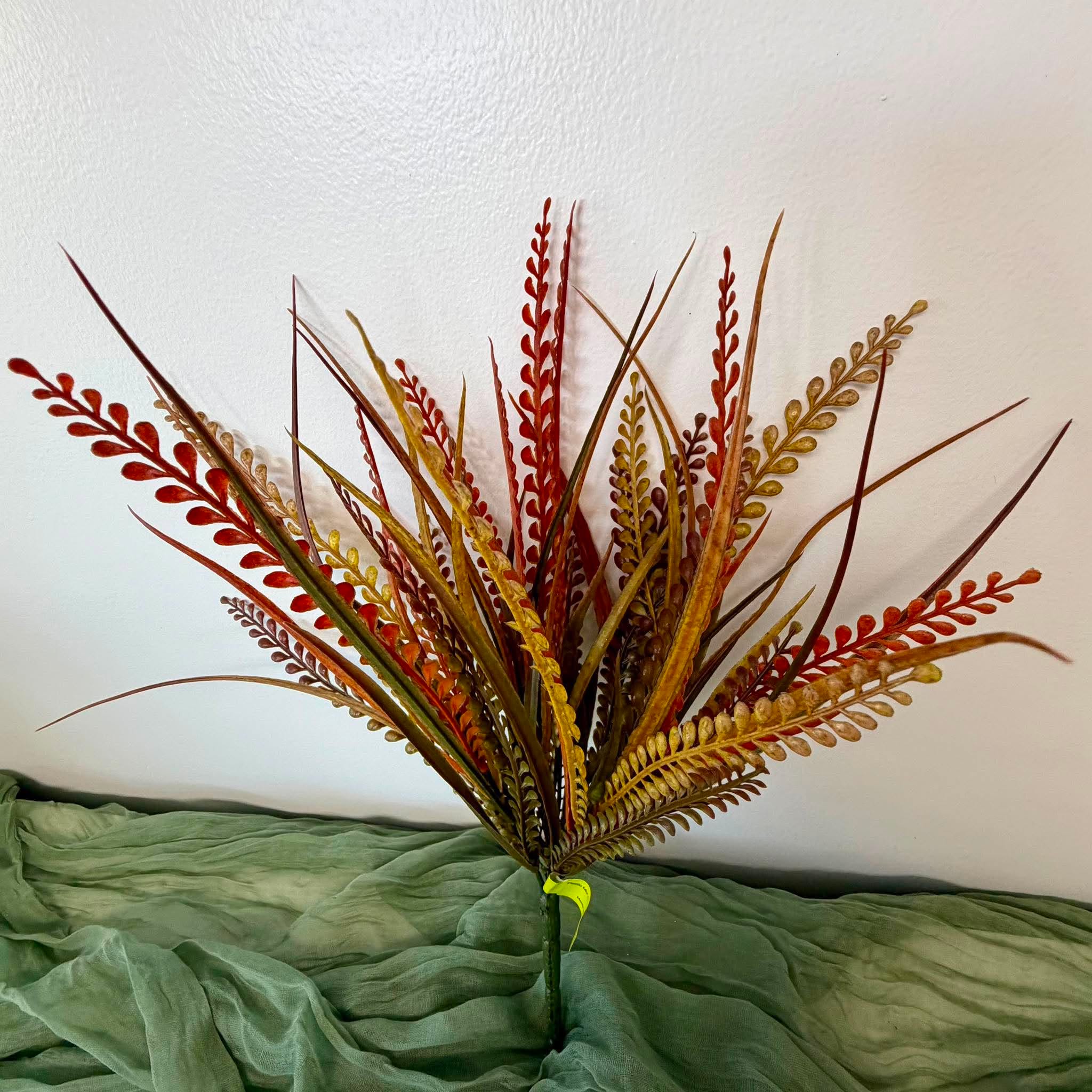 Close Up of Orange Rust and Olive Grass Blades and Fern Fronds on Fall Bush