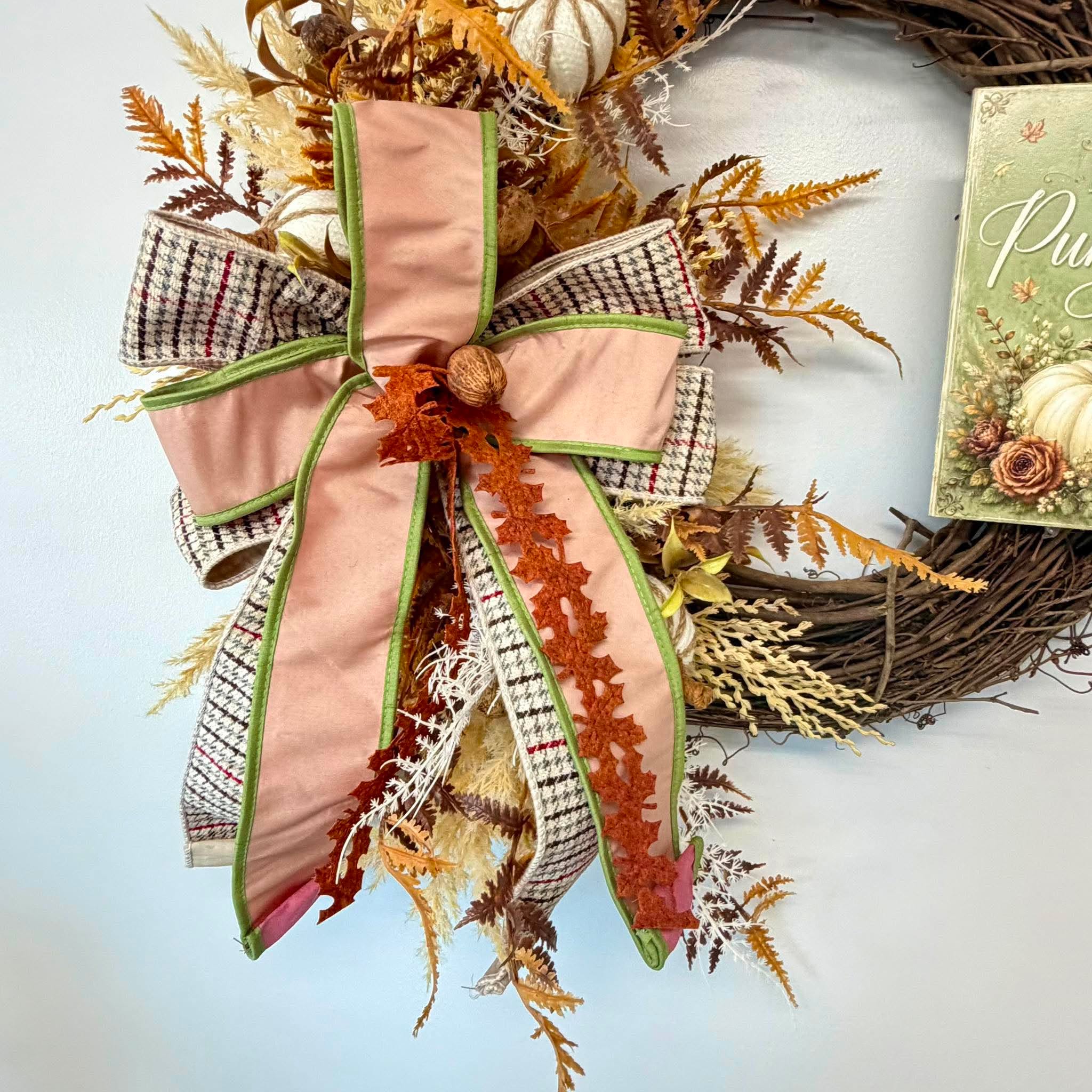 Blush velvet and houndstooth plaid bow with rust cut-leaf trim against gold dried ferns