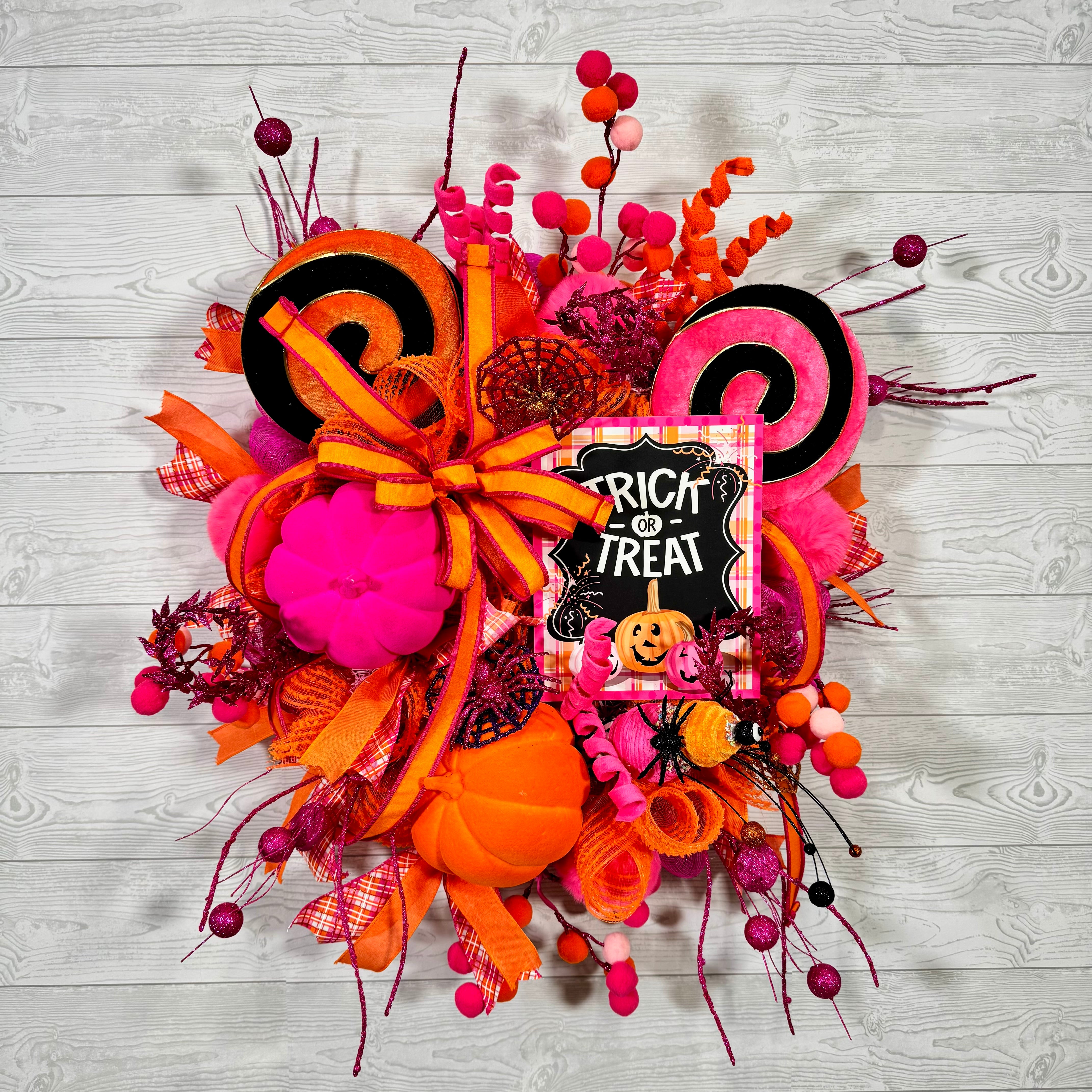 Bright Pink and Orange Halloween Wreath with Trick or Treat Sign, Pumpkins, Candy Swirls, and Whimsical Spooky Accents