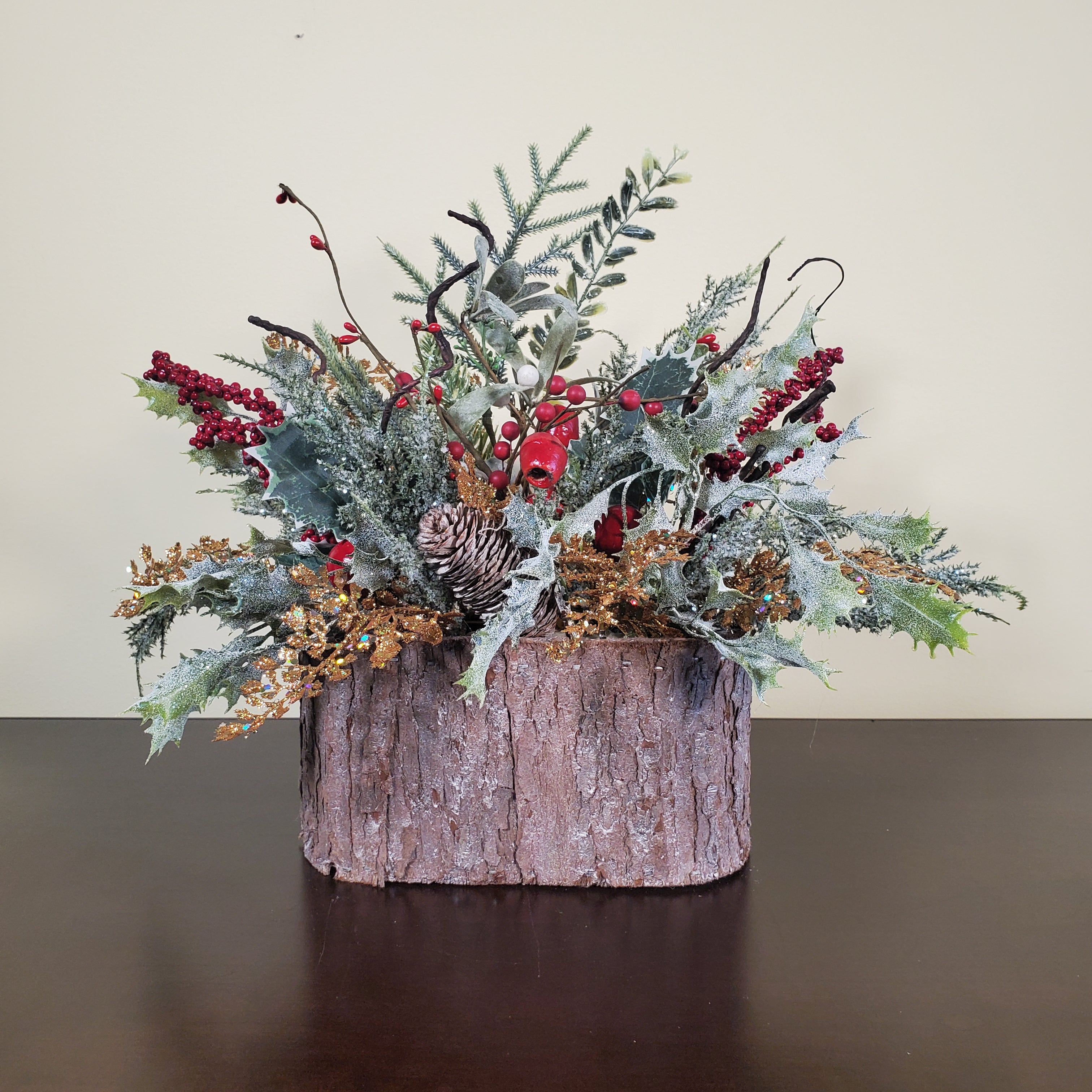 Frosted Christmas Arrangement with Red Berries, Pinecones, and Winter Greens in Bark-Style Container