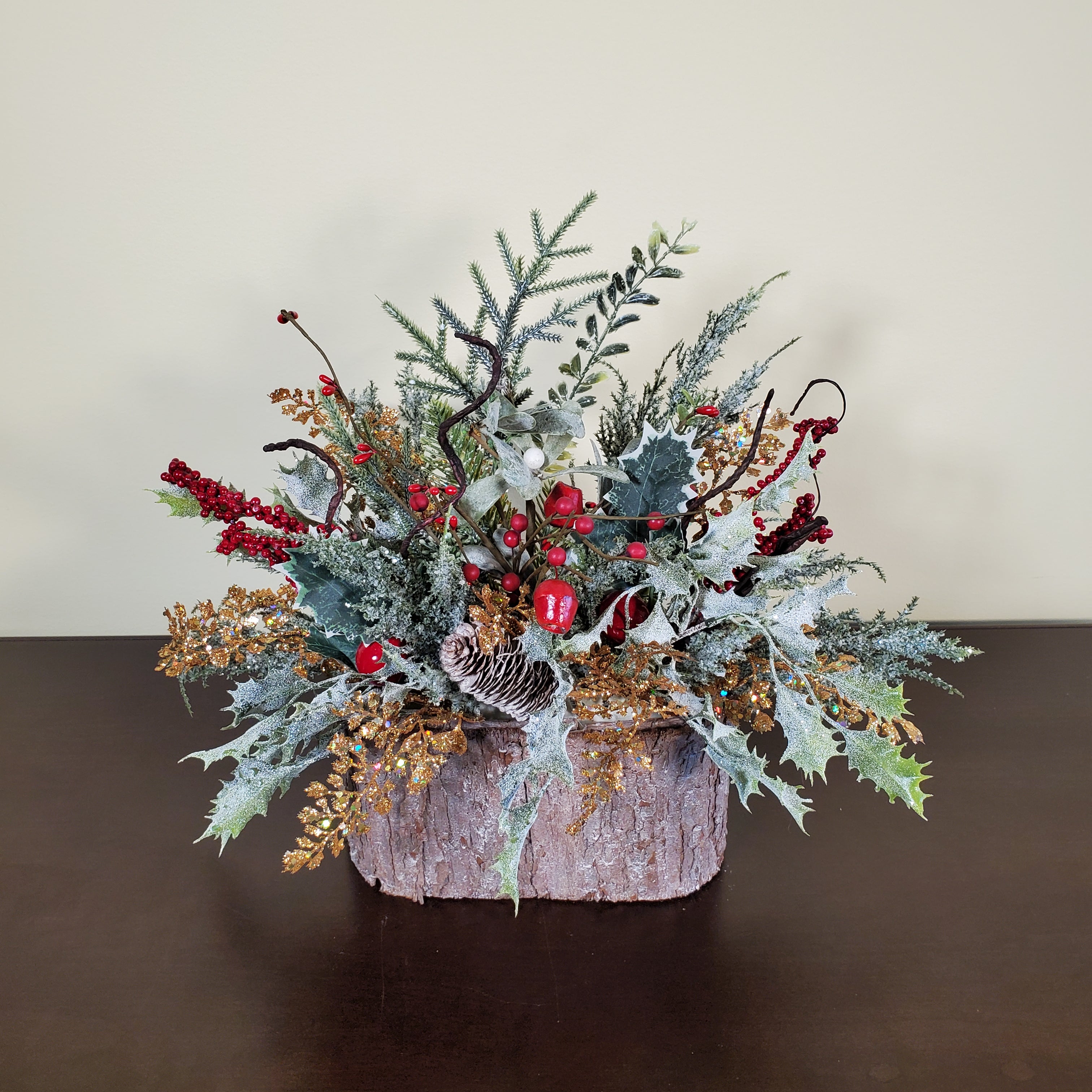 Frosted Christmas Arrangement with Red Berries, Pinecones, and Winter Greens in Bark-Style Container