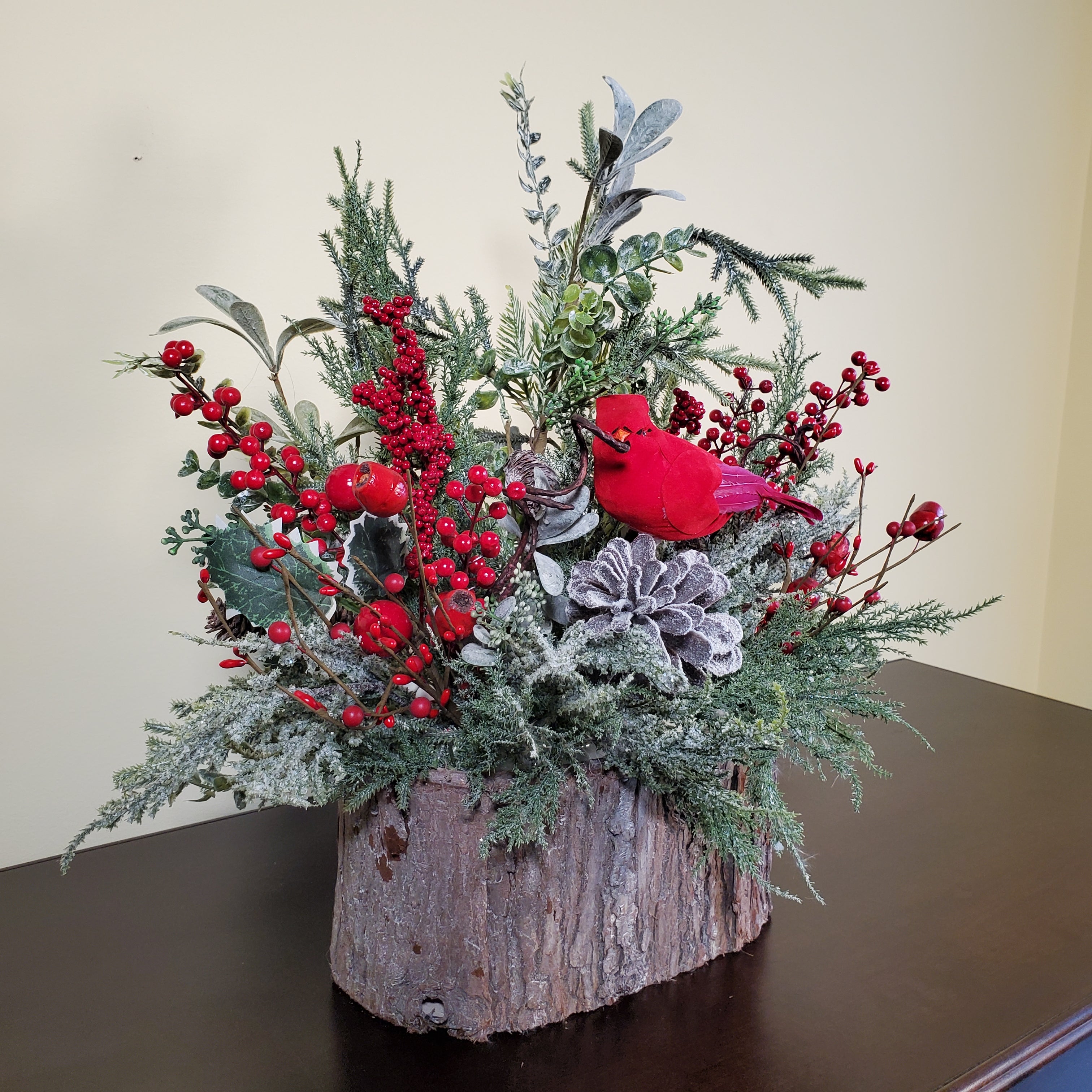 Cardinal Christmas Arrangement with Frosted Pine, Red Berries, and Winter Greens in Bark-Style Container