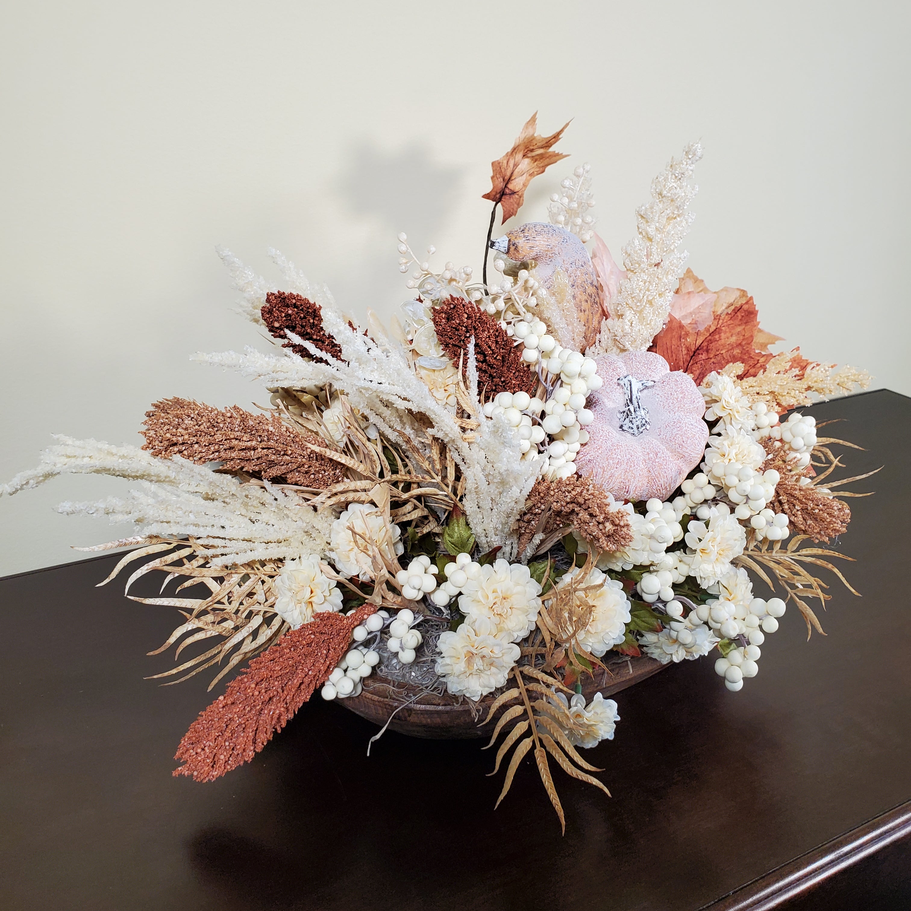 Neutral Fall Pumpkin Centerpiece with Cream Florals, White Berries, and Autumn Grasses in Rustic Oval Base
