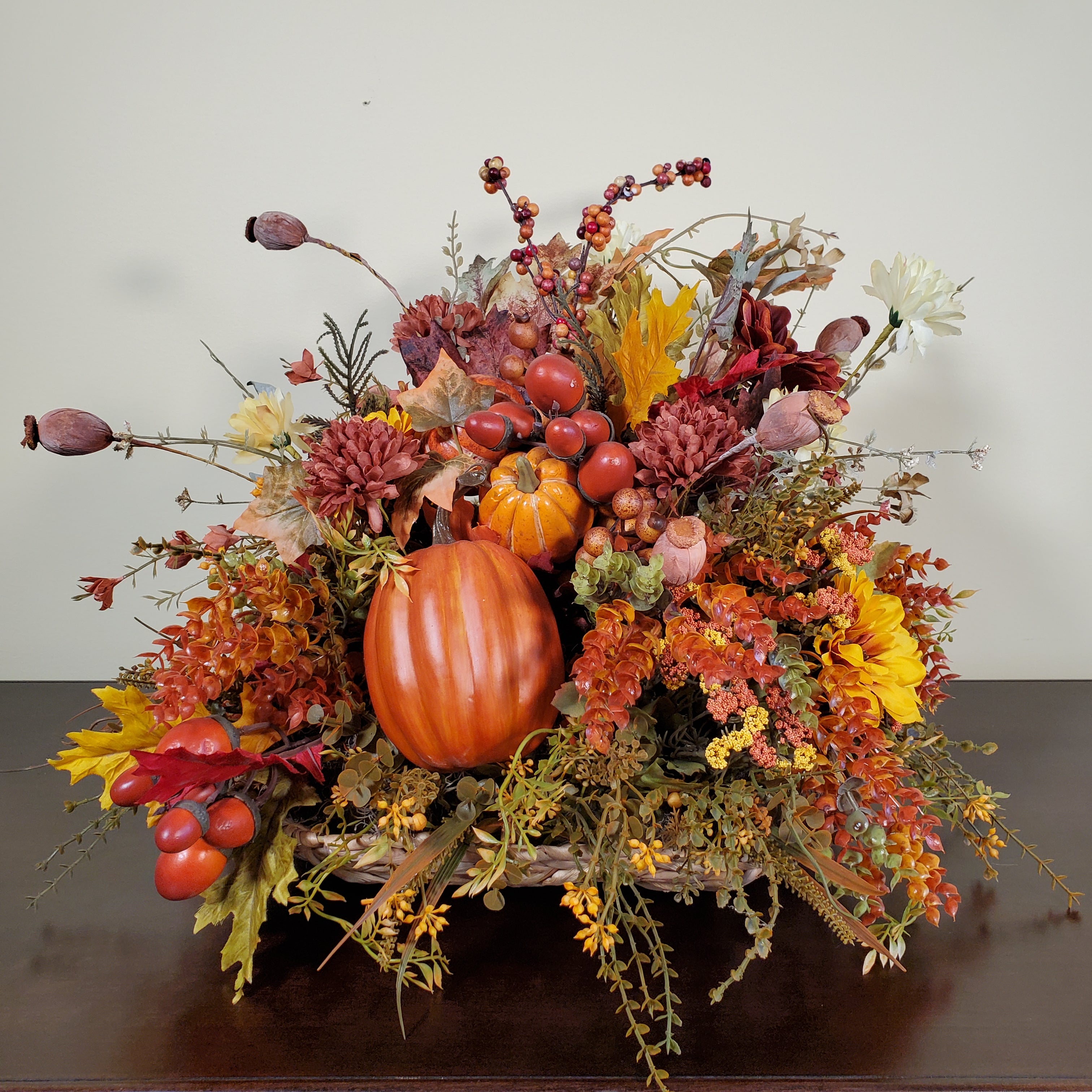 Fall Pumpkin Centerpiece with Autumn Leaves, Berries, and Seasonal Florals in Warm Harvest Colors