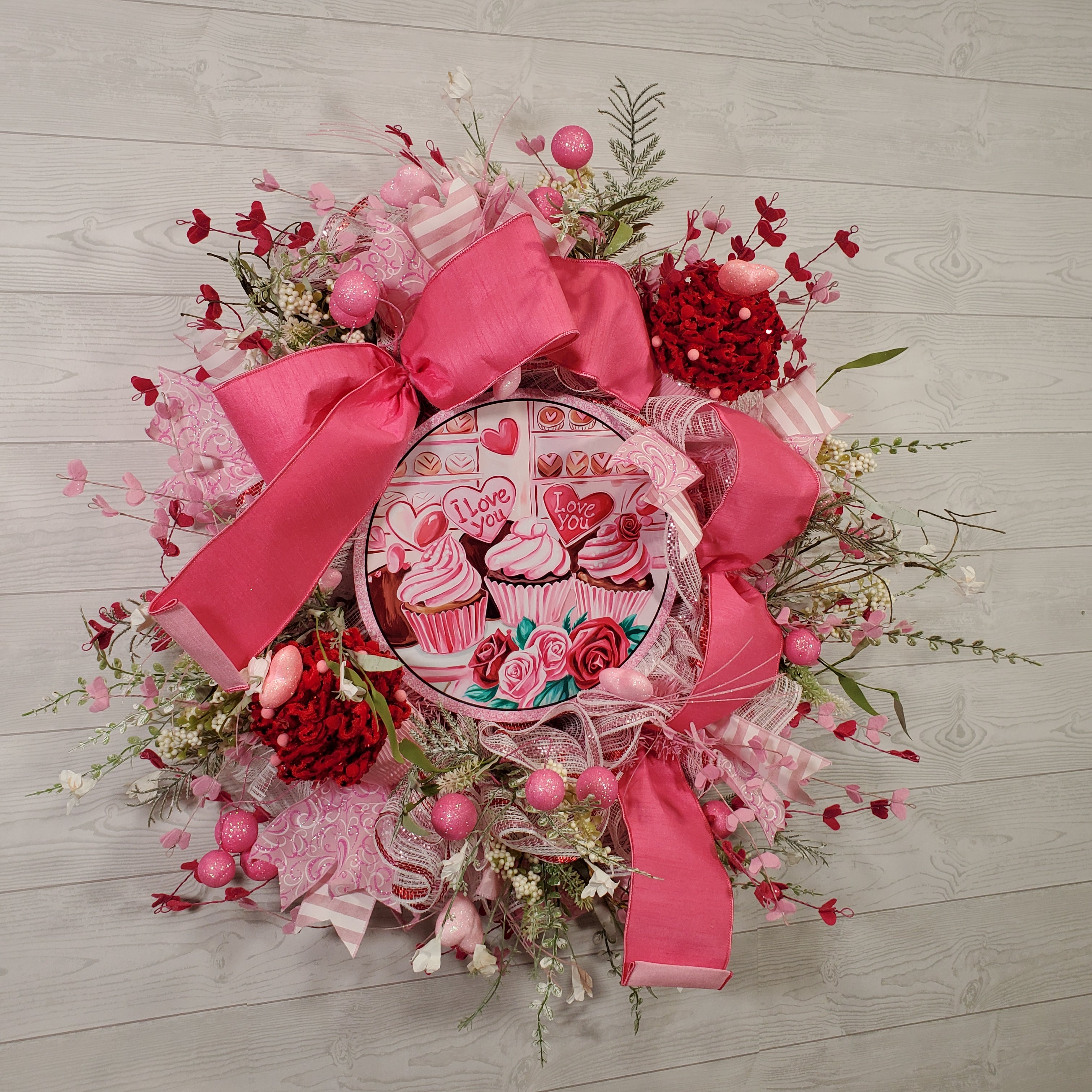 Valentine Cupcake Wreath with Pink Bow, Heart Accents, Sweet Treat Artwork, and Romantic Pink Floral Design