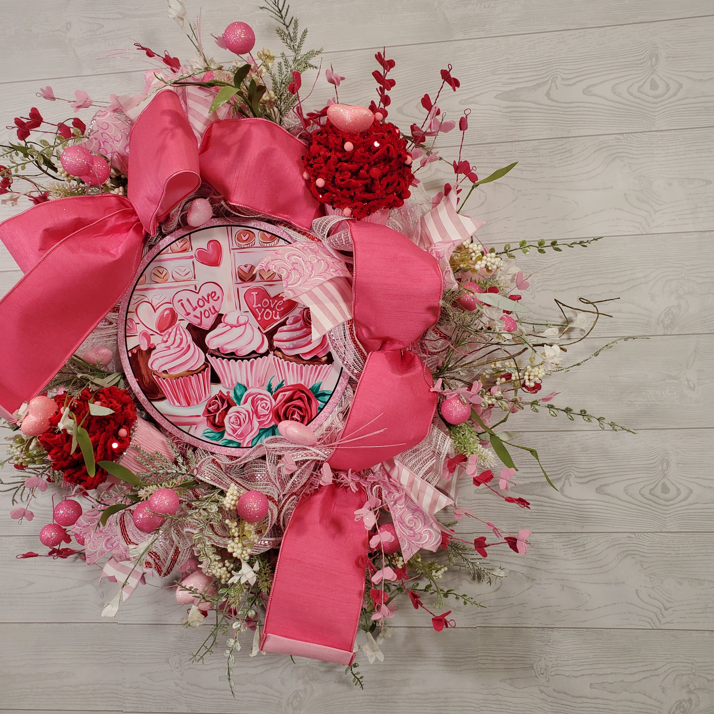 Valentine Cupcake Wreath with Pink Bow, Heart Accents, Sweet Treat Artwork, and Romantic Pink Floral Design