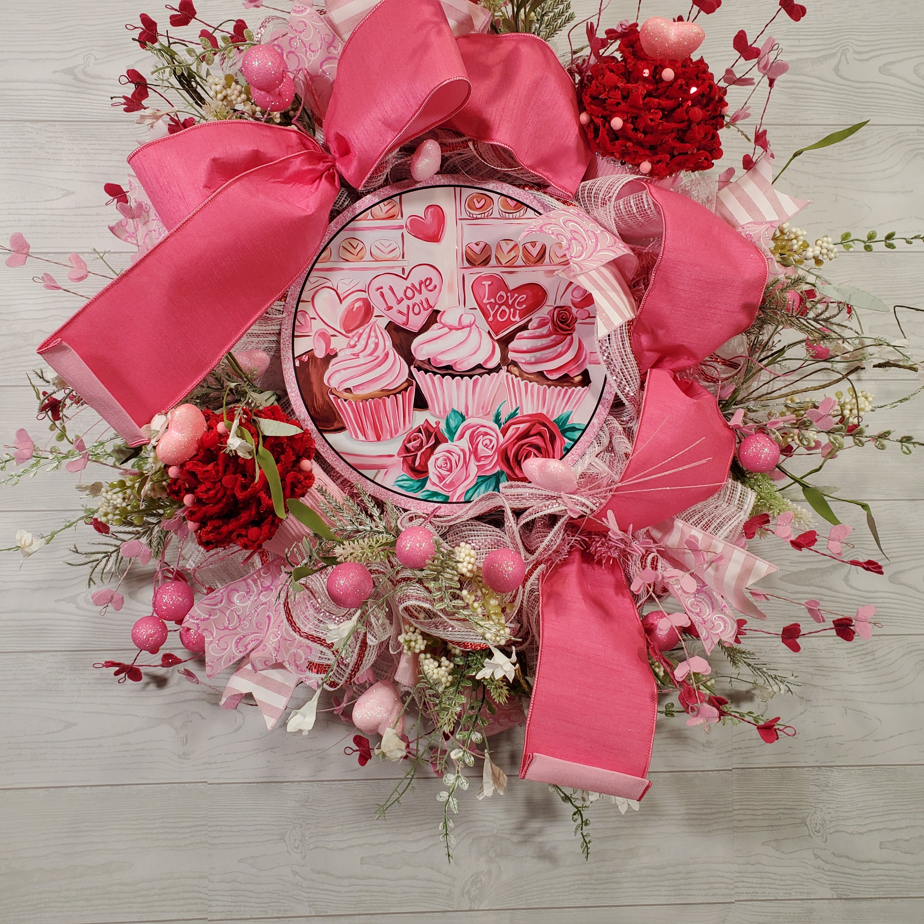 Valentine Cupcake Wreath with Pink Bow, Heart Accents, Sweet Treat Artwork, and Romantic Pink Floral Design