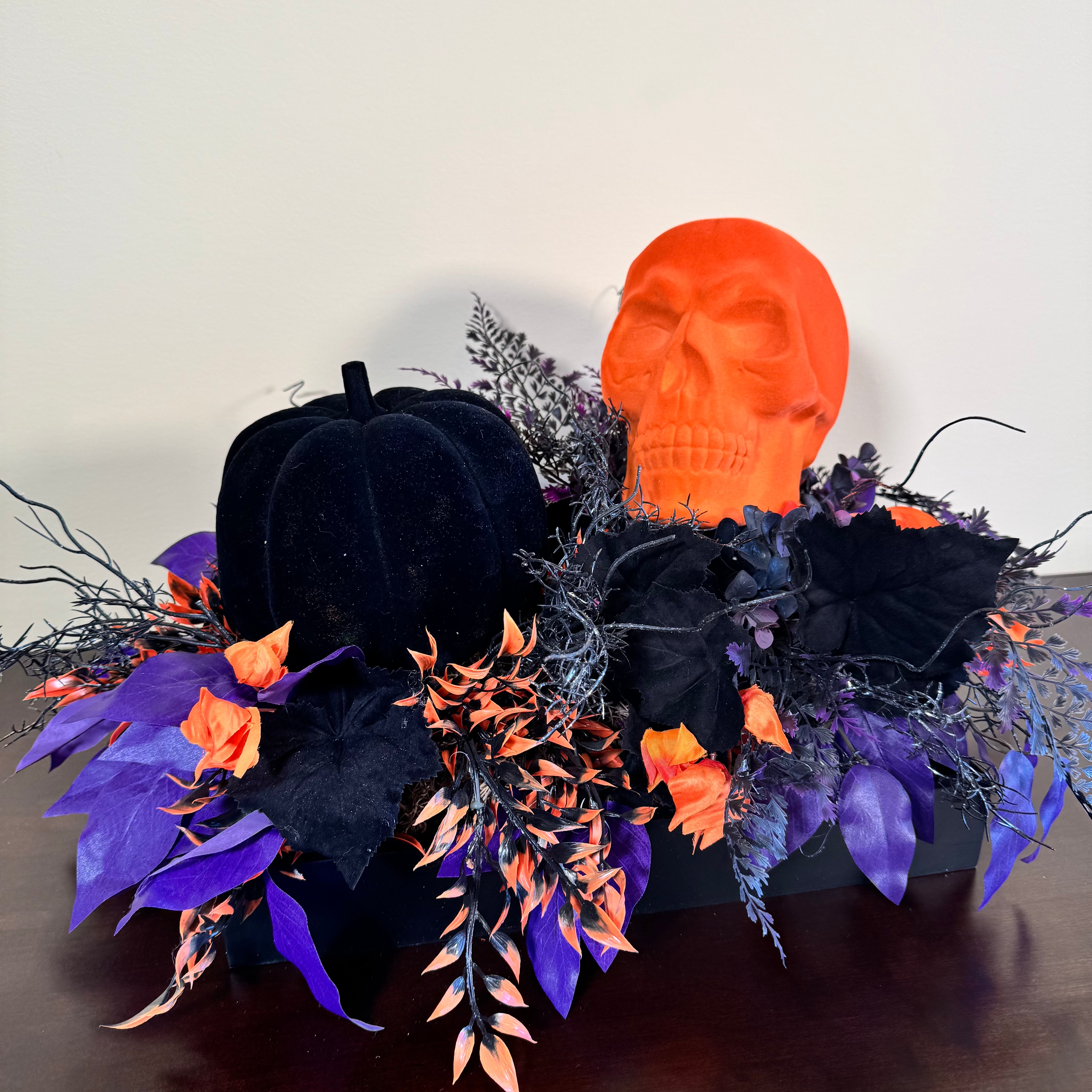 Halloween Arrangement with Neon Skull, Velvet Pumpkin & Bold Foliage in Black Wooden Tray