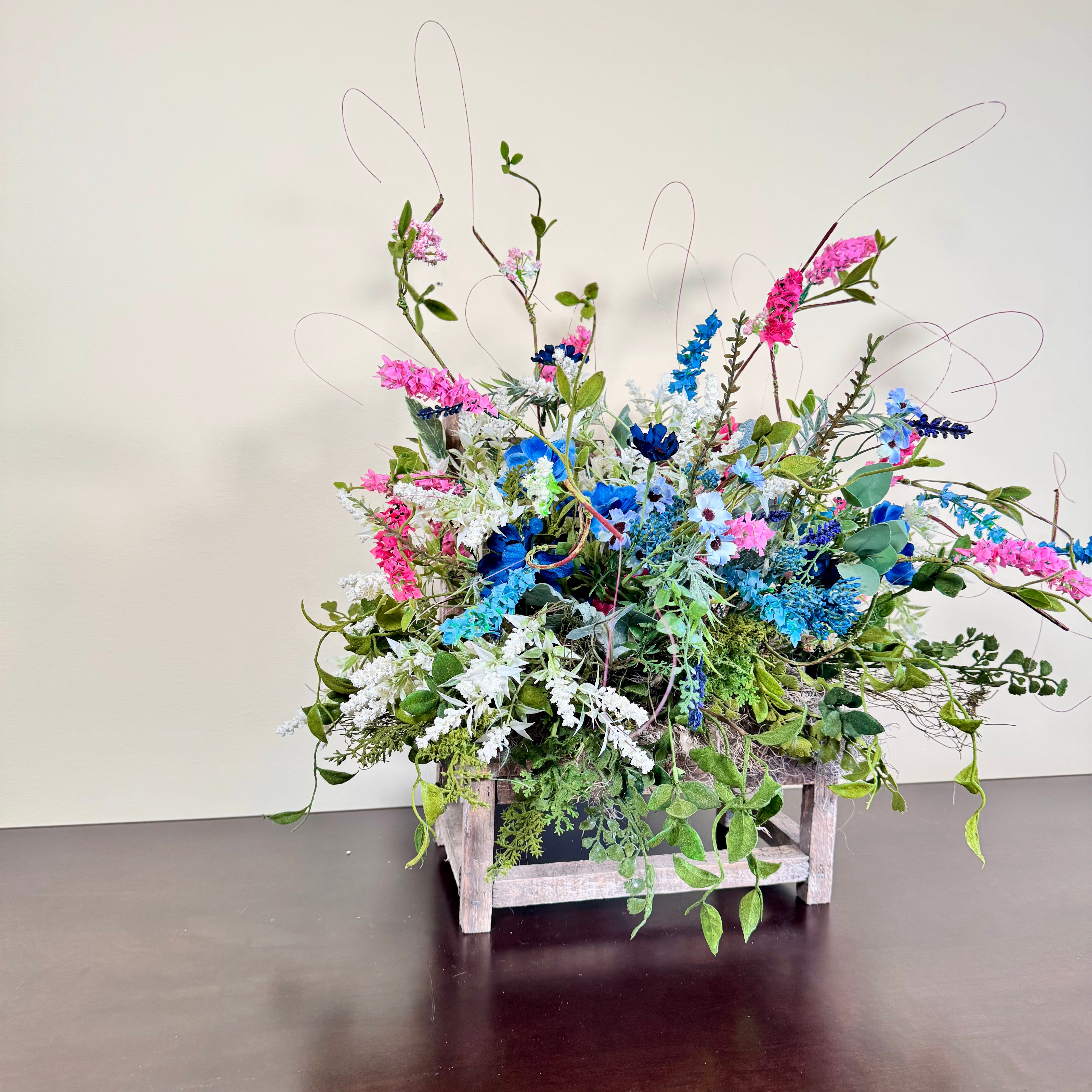 Wildflower Meadow Arrangement with Pink and Blue Blooms on Weathered Wooden Bench