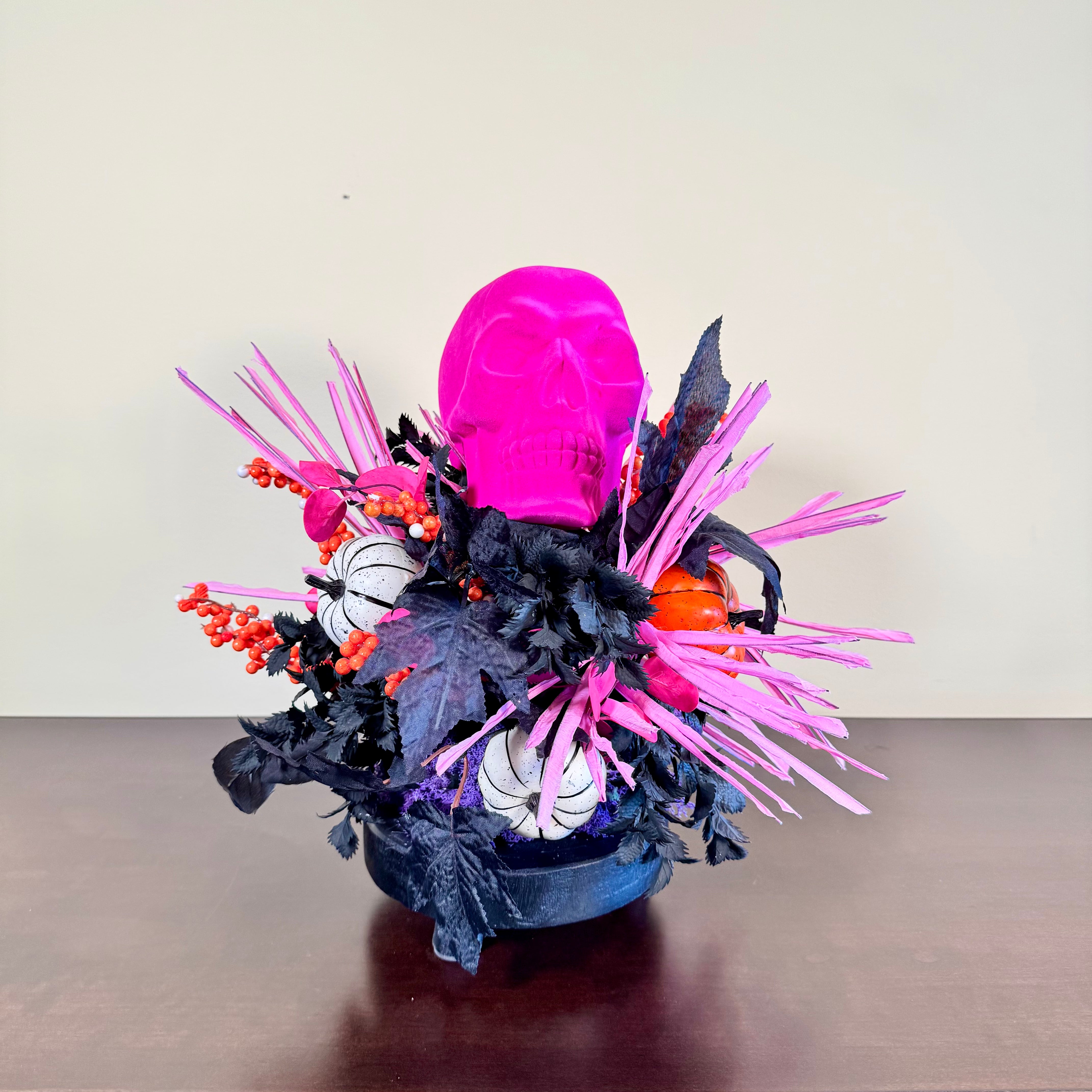 Pink Skull Halloween Arrangement with Black Foliage, Pumpkins and Neon Accents