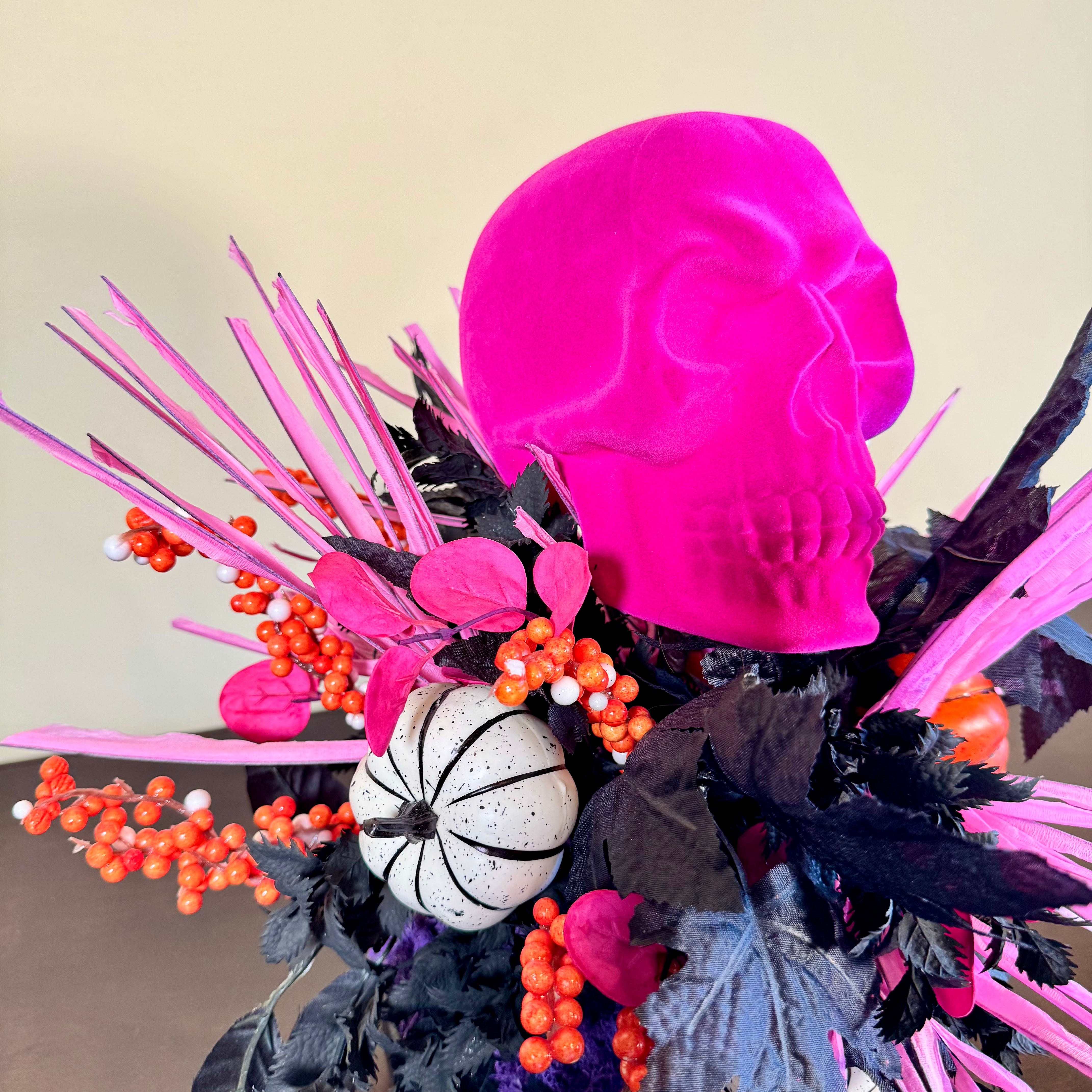Pink Skull Halloween Arrangement with Black Foliage, Pumpkins and Neon Accents