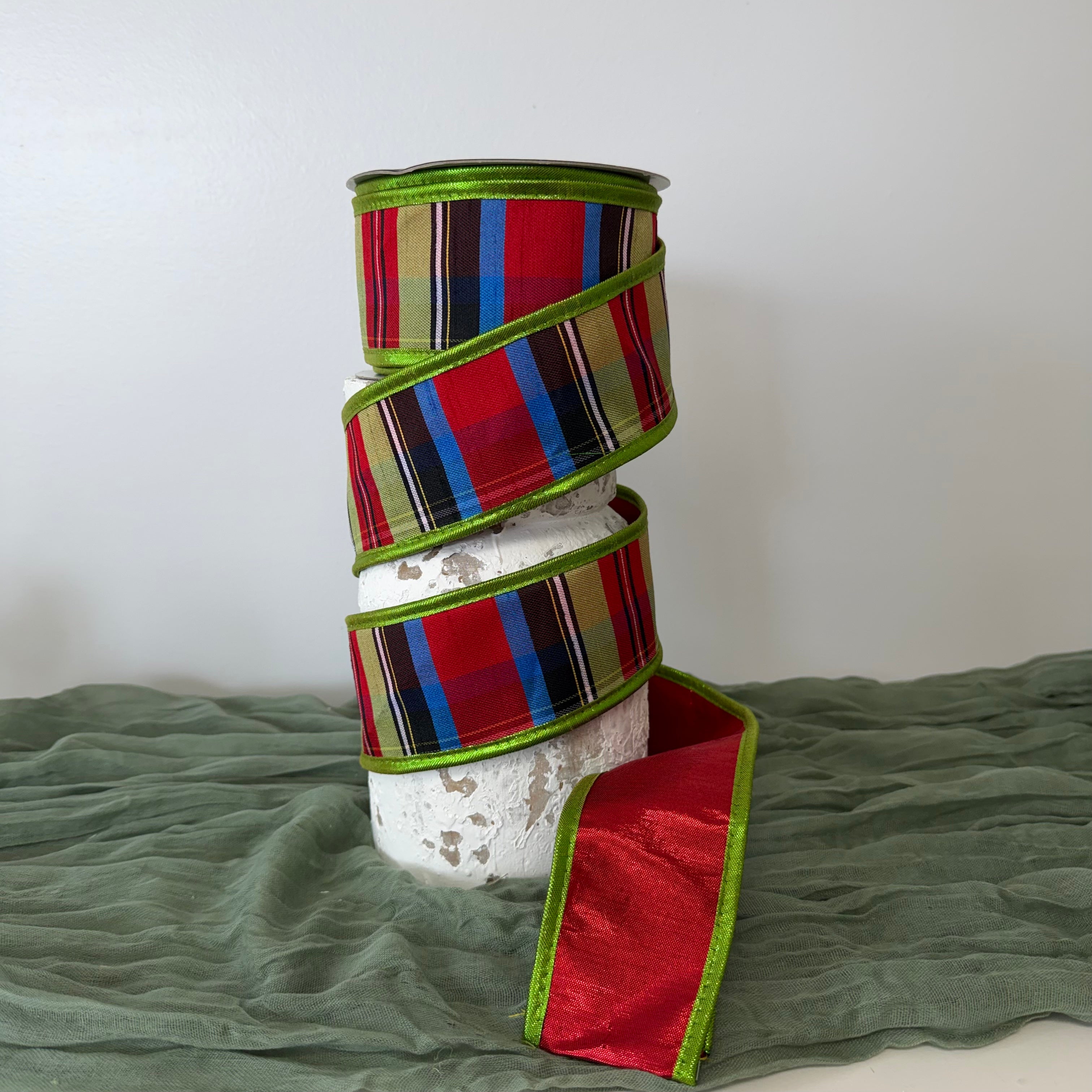 Luxury Nutcracker Christmas ribbon featuring red, green, black, yellow, blue and white stripes with metallic green piping and extra-strong wired edges.
