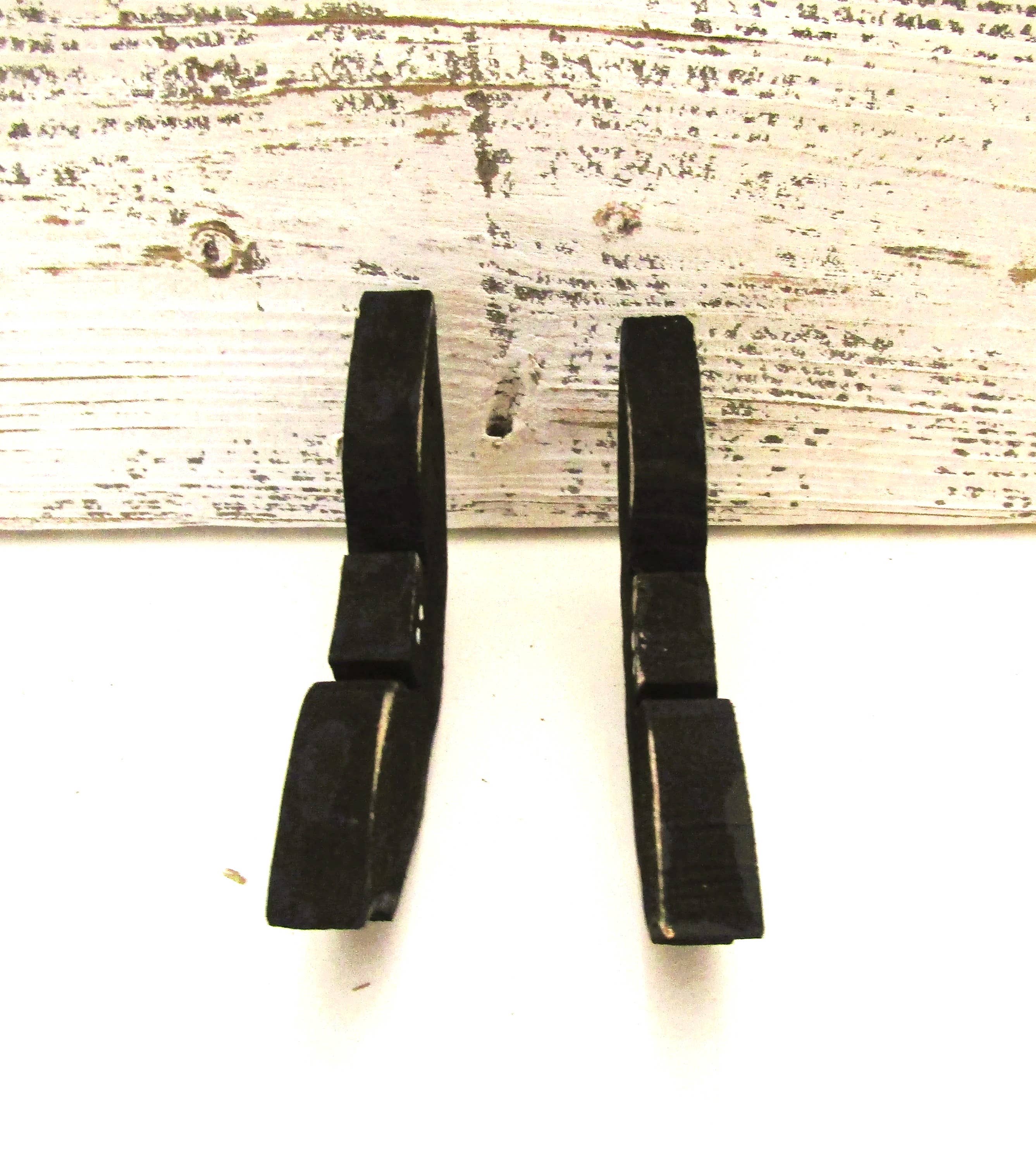 Side view of two wood Halloween bats showing the 1/2 inch thickness and black painted back
