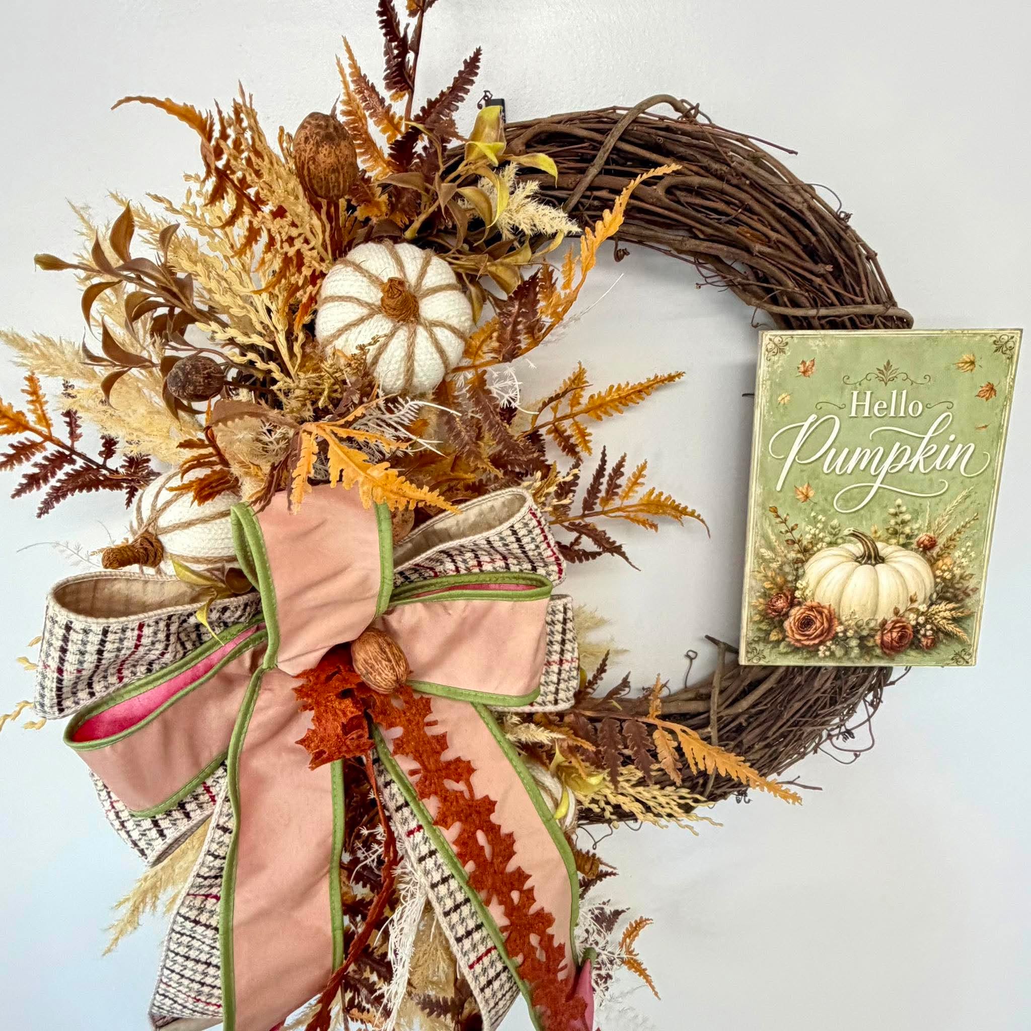 Fall grapevine wreath with dried ferns, pampas plumes and a blush velvet bow beside the Hello Pumpkin sign