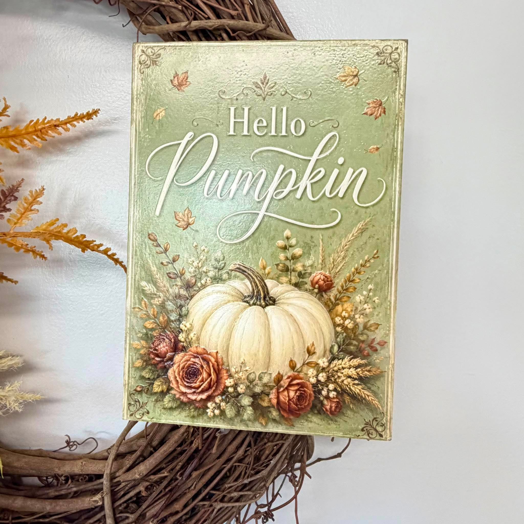 Close-up of the vintage sage green Hello Pumpkin sign with a white pumpkin and dusty rose roses
