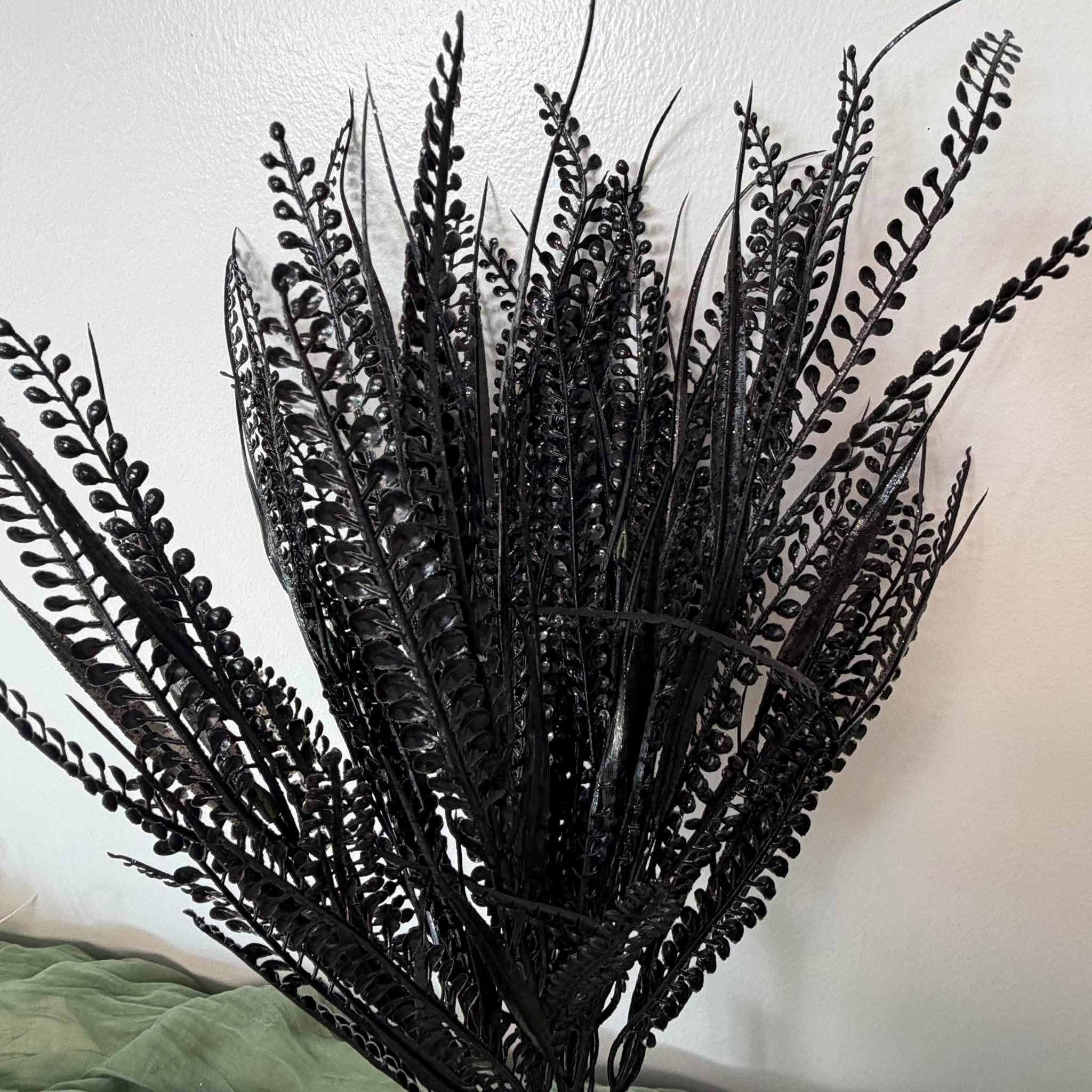 Close Up of Glossy Black Fern Fronds and Bead Grass on Artificial Wreath Bush